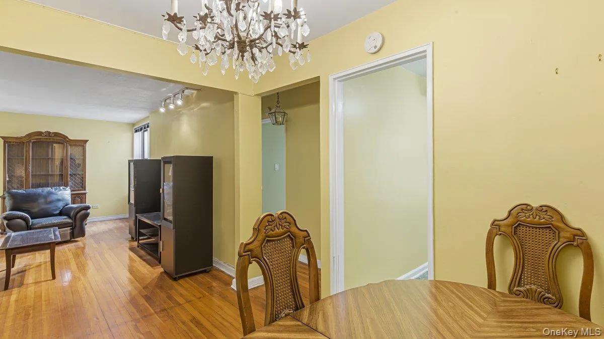 Dining space with hardwood / wood-style floors, a chandelier, and rail lighting Dining space with hardwood / wood-style floors, a chandelier, and rail lighting