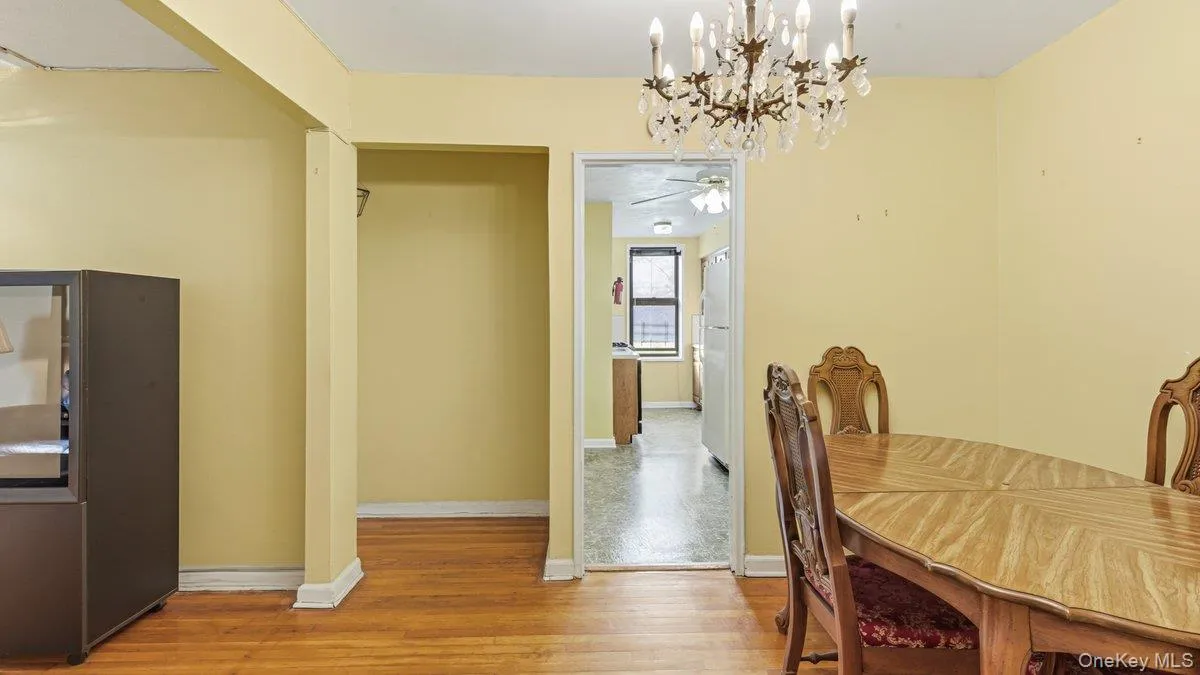 Dining space featuring light wood-type flooring and a chandelier Dining space featuring light wood-type flooring and a chandelier