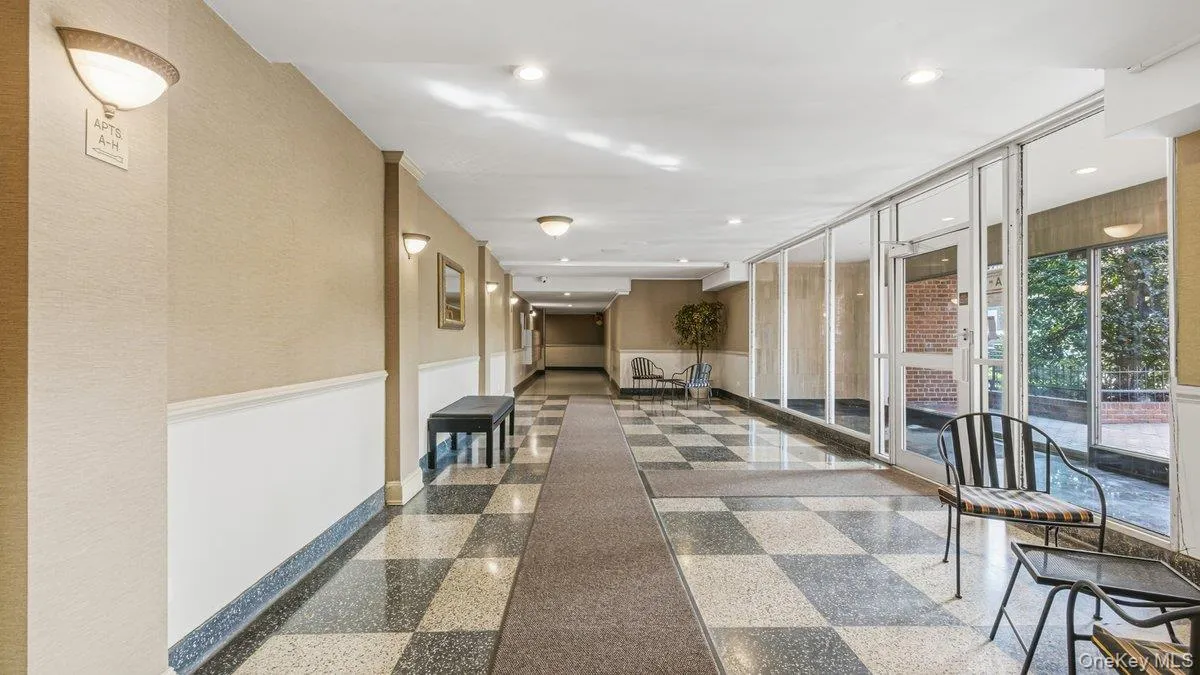 Corridor featuring a wainscoted wall and recessed lighting Corridor featuring a wainscoted wall and recessed lighting