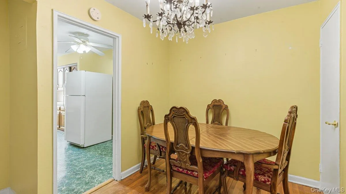 Dining area featuring wood finished floors and a chandelier Dining area featuring wood finished floors and a chandelier
