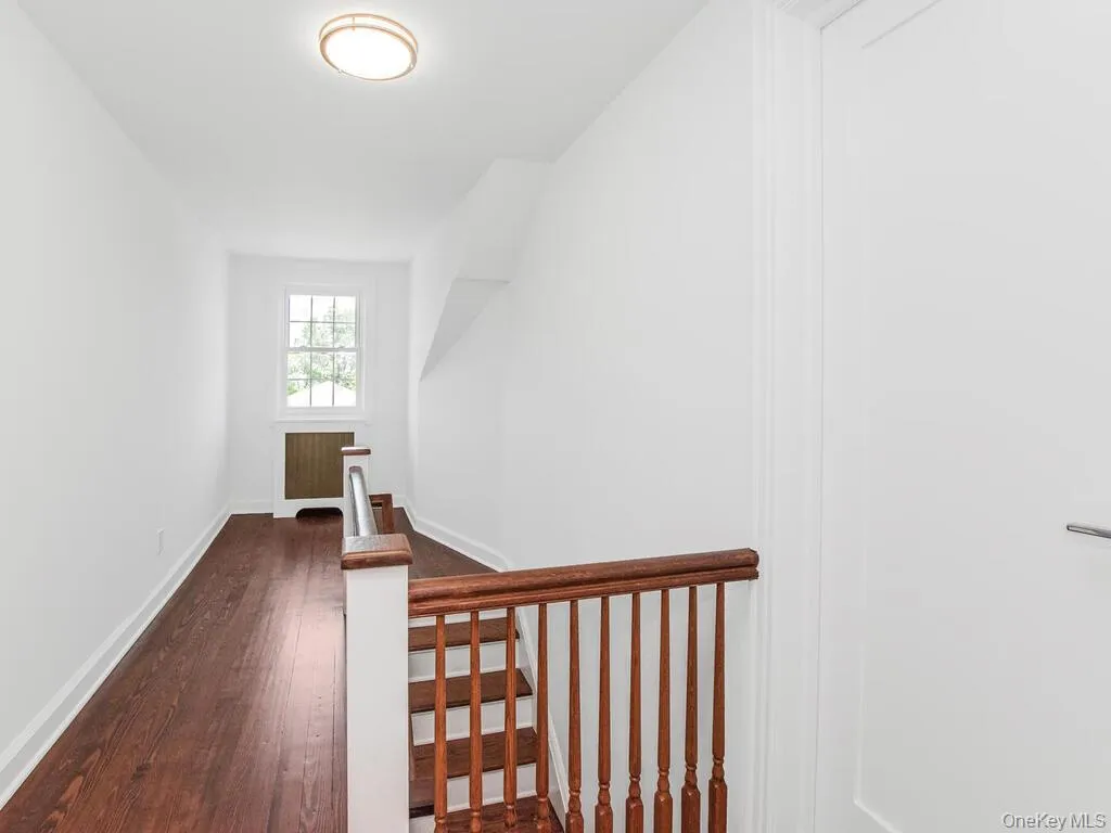 Staircase with hardwood / wood-style flooring and baseboards Staircase with hardwood / wood-style flooring and baseboards