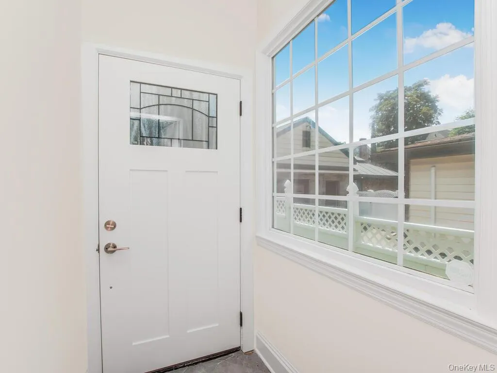 Doorway featuring baseboards Doorway featuring baseboards