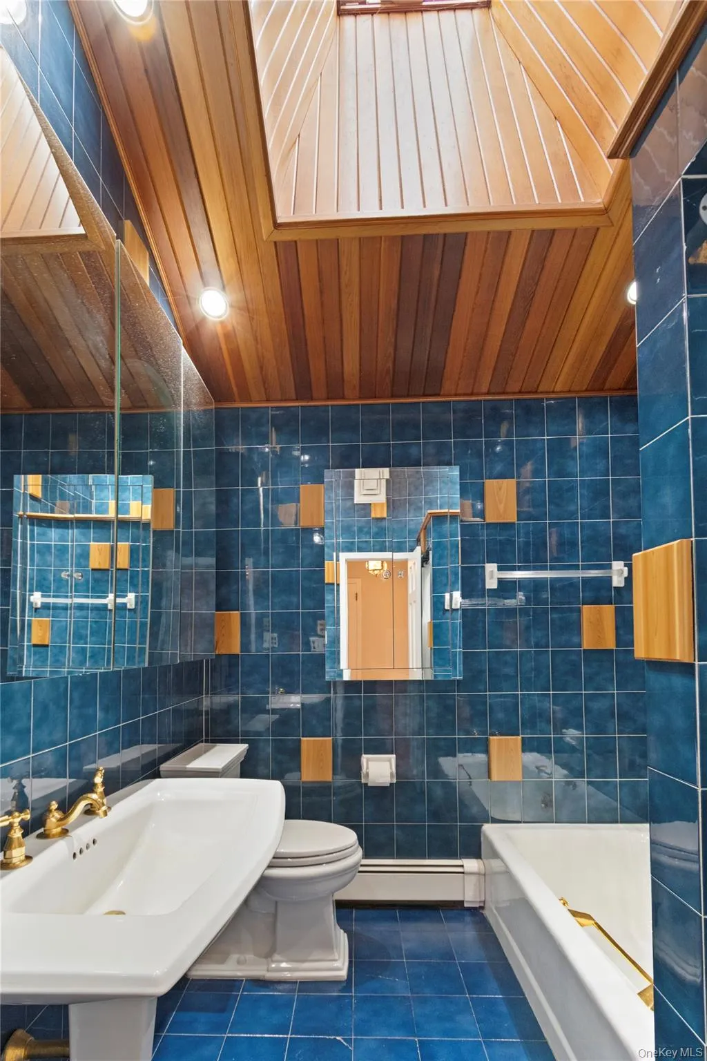 Full bath with tile patterned floors, tile walls, a baseboard radiator, wood ceiling, and lofted ceiling Full bath with tile patterned floors, tile walls, a baseboard radiator, wood ceiling, and lofted ceiling