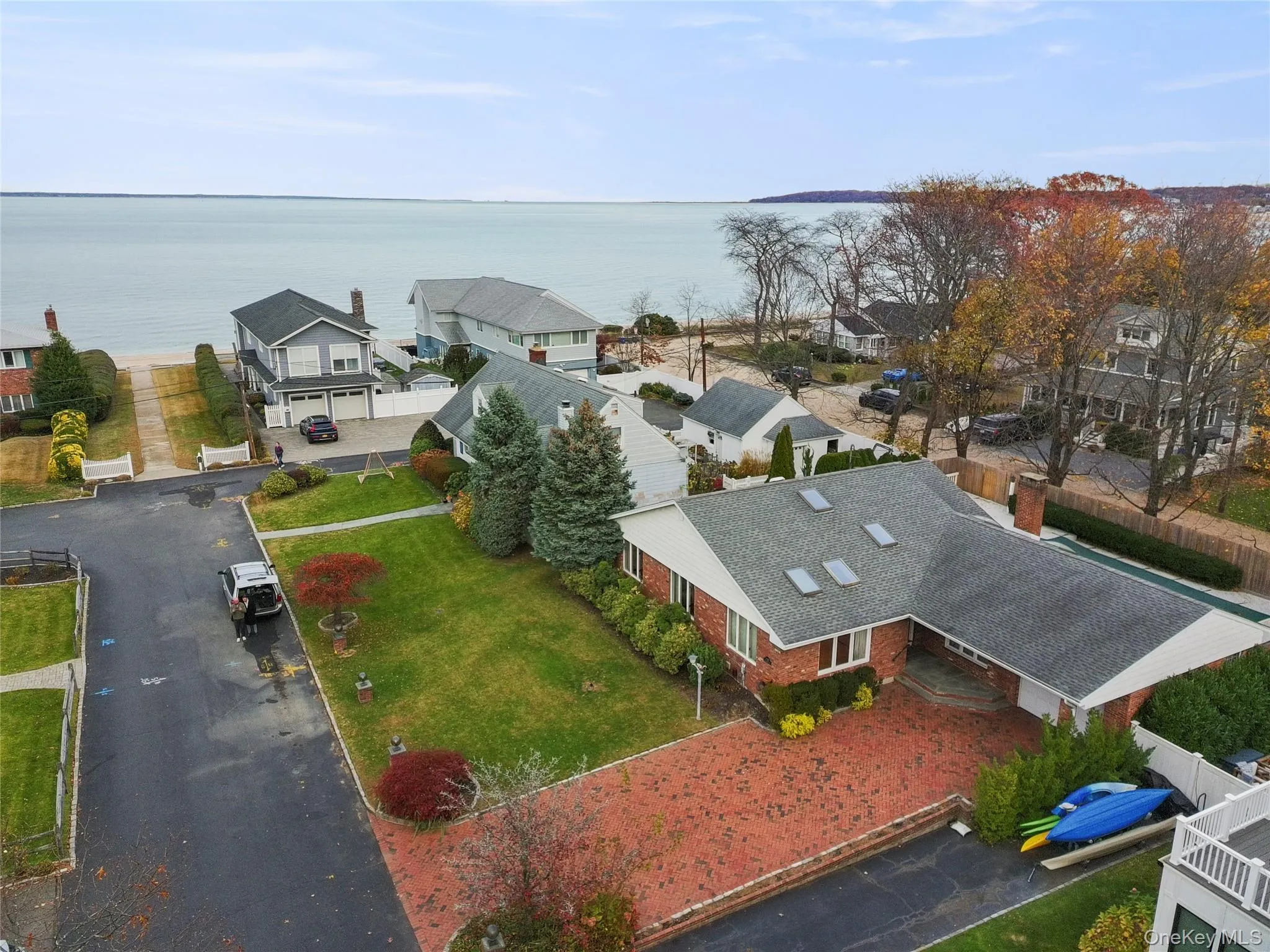 Aerial view of residential area featuring a large body of water Aerial view of residential area featuring a large body of water