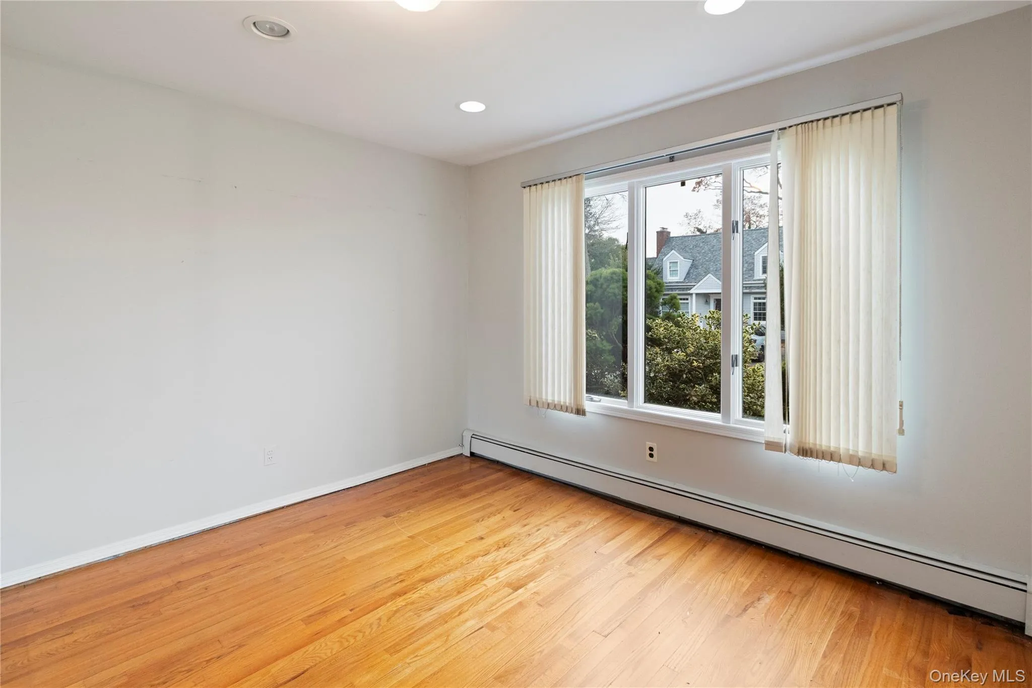 Spare room featuring a baseboard heating unit, light wood finished floors, and recessed lighting Spare room featuring a baseboard heating unit, light wood finished floors, and recessed lighting
