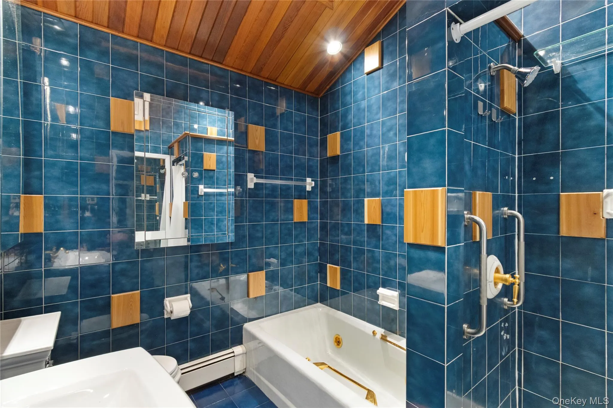 Bathroom featuring tile walls, tiled shower, a baseboard heating unit, tile patterned floors, and wooden ceiling Bathroom featuring tile walls, tiled shower, a baseboard heating unit, tile patterned floors, and wooden ceiling