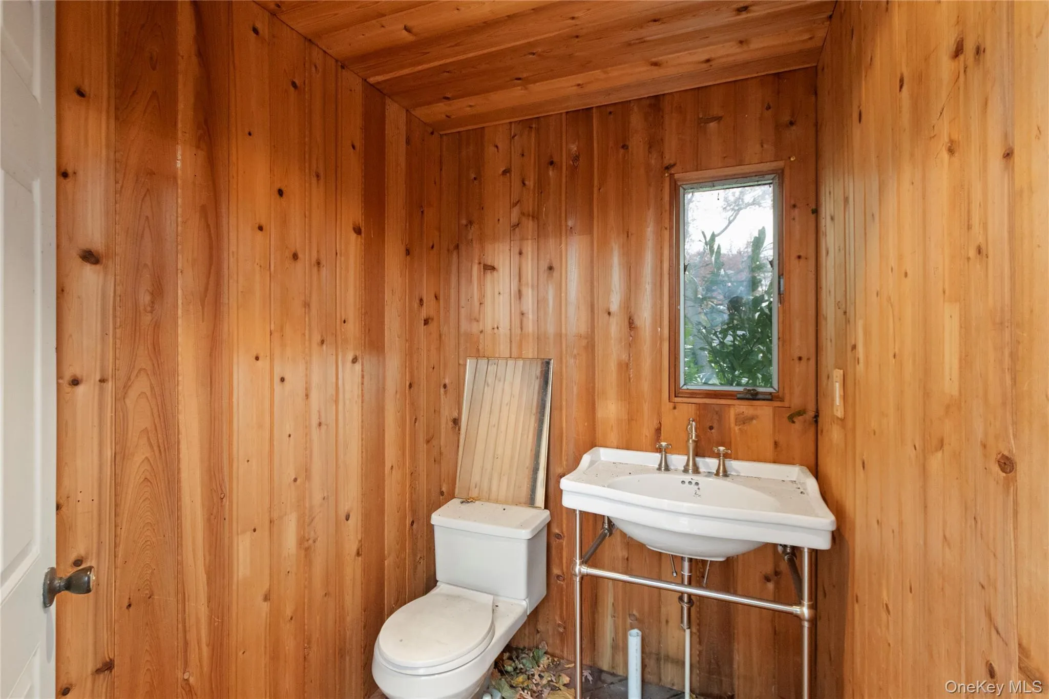 Half bath with toilet and a sink Half bath with toilet and a sink