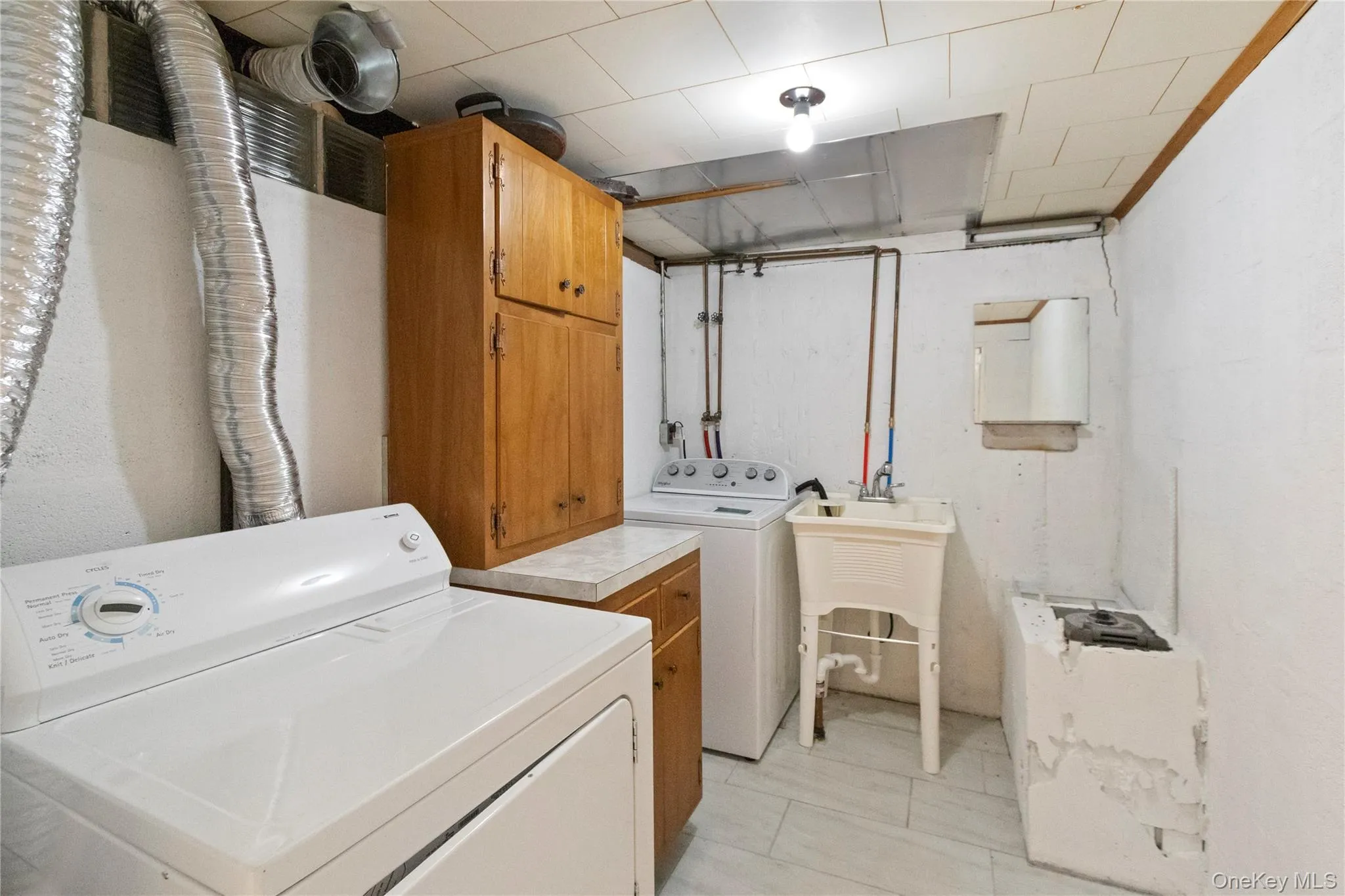 Laundry room featuring cabinet space and washing machine and dryer Laundry room featuring cabinet space and washing machine and dryer