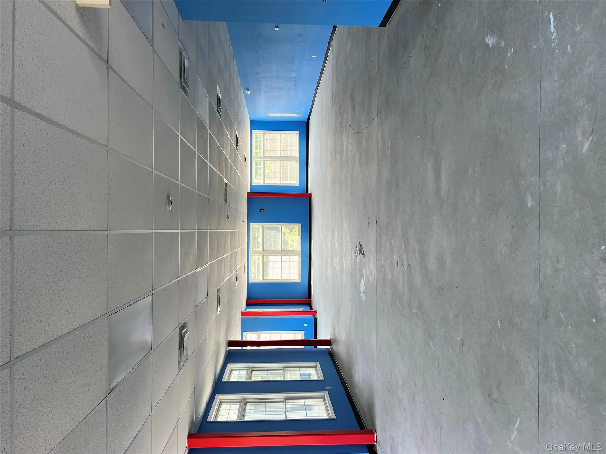Empty room featuring concrete flooring and a paneled ceiling Empty room featuring concrete flooring and a paneled ceiling