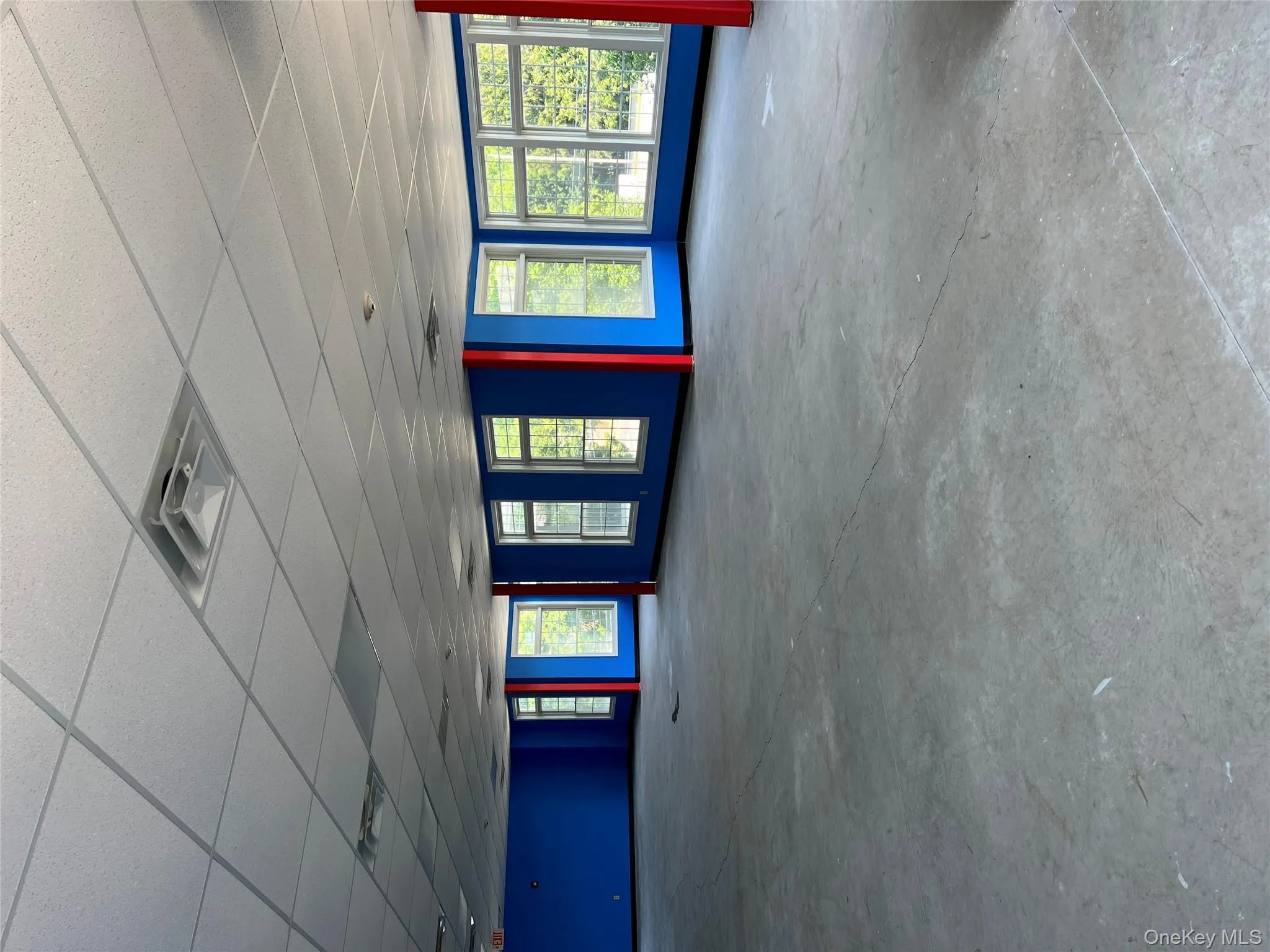 Spare room featuring unfinished concrete floors and a drop ceiling Spare room featuring unfinished concrete floors and a drop ceiling