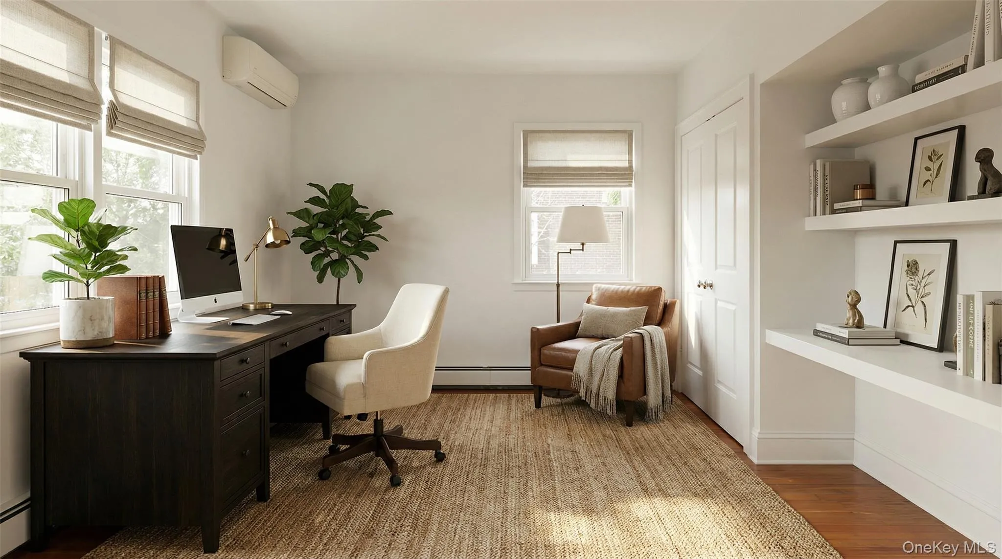 Office area featuring a wall unit AC, light wood-type flooring, and baseboard heating Office area featuring a wall unit AC, light wood-type flooring, and baseboard heating