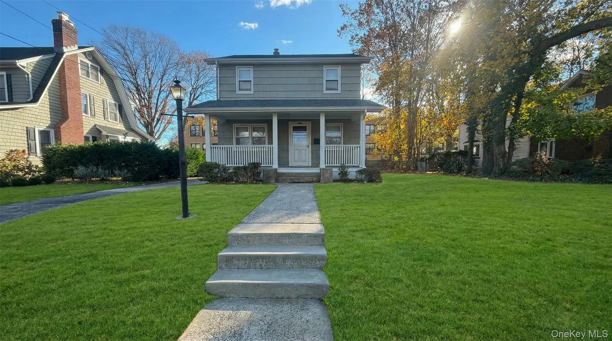 View of front of home featuring covered porch and a front yard View of front of home featuring covered porch and a front yard