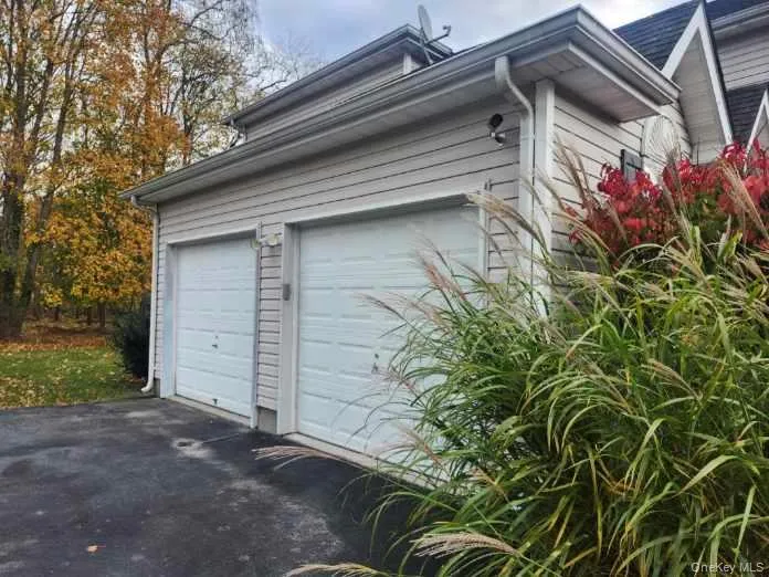 Garage featuring asphalt driveway Garage featuring asphalt driveway
