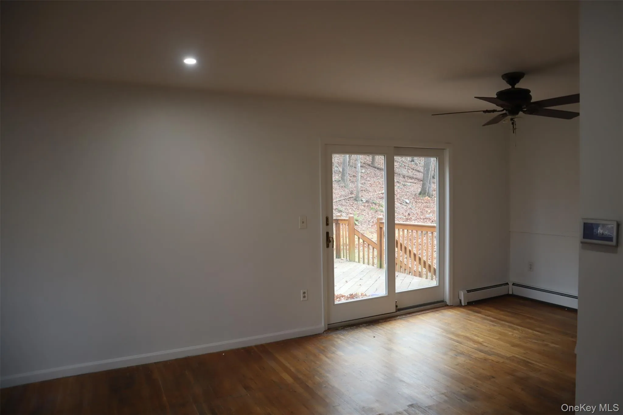 Unfurnished room with wood finished floors, ceiling fan, and recessed lighting Unfurnished room with wood finished floors, ceiling fan, and recessed lighting