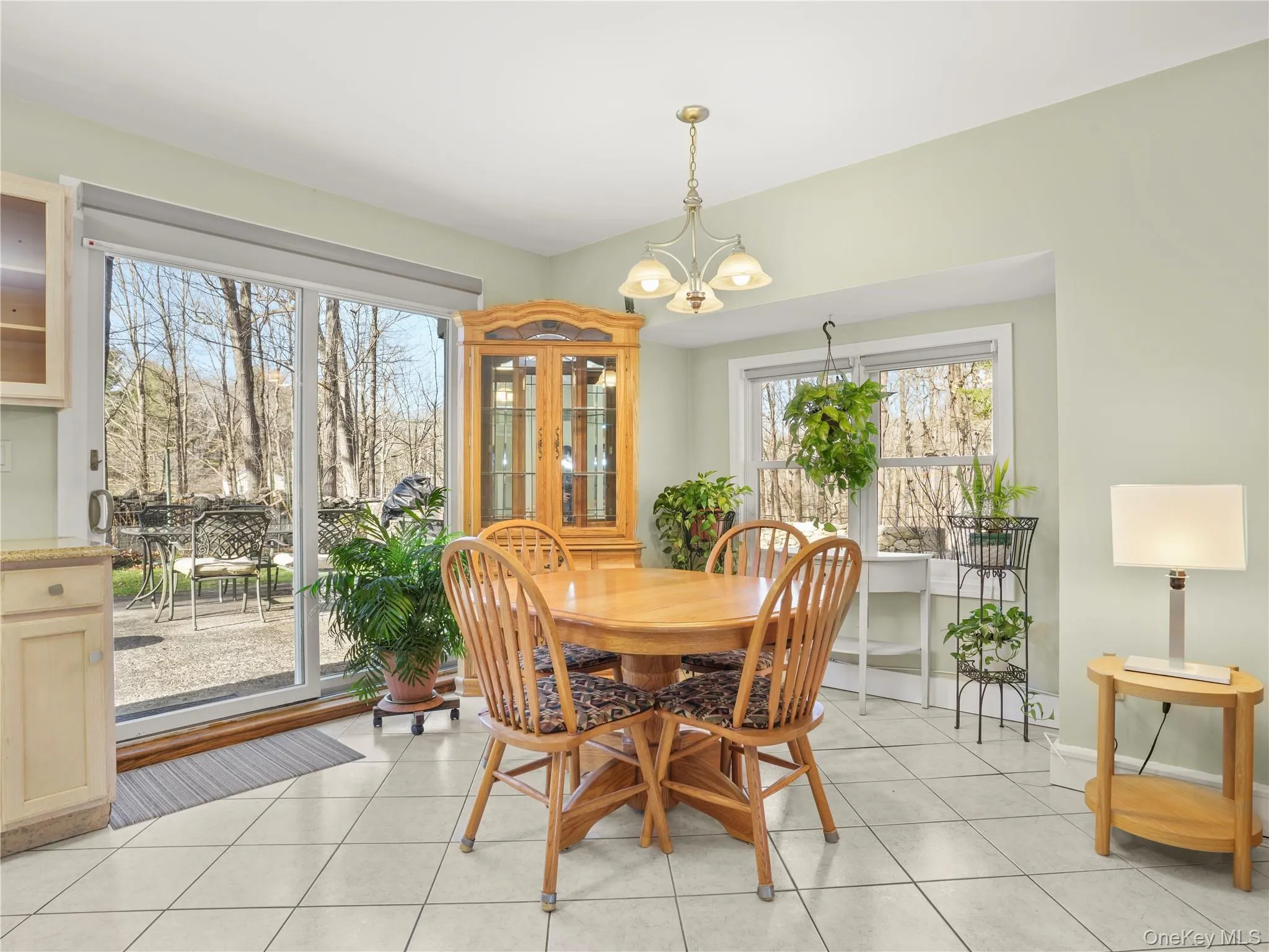 Dining space featuring light tile patterned floors and a chandelier Dining space featuring light tile patterned floors and a chandelier