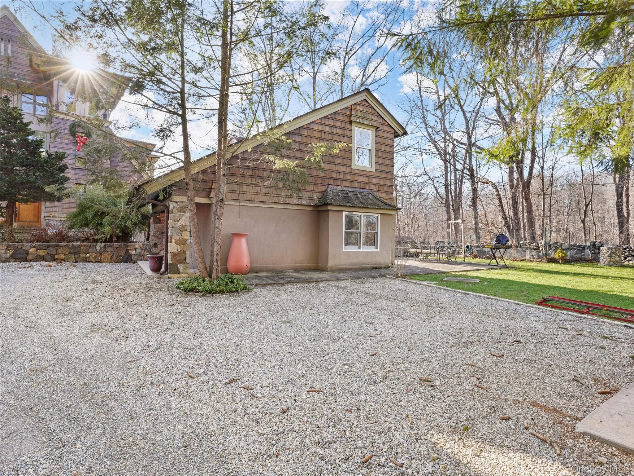 View of home's exterior with a lawn and stone siding View of home's exterior with a lawn and stone siding