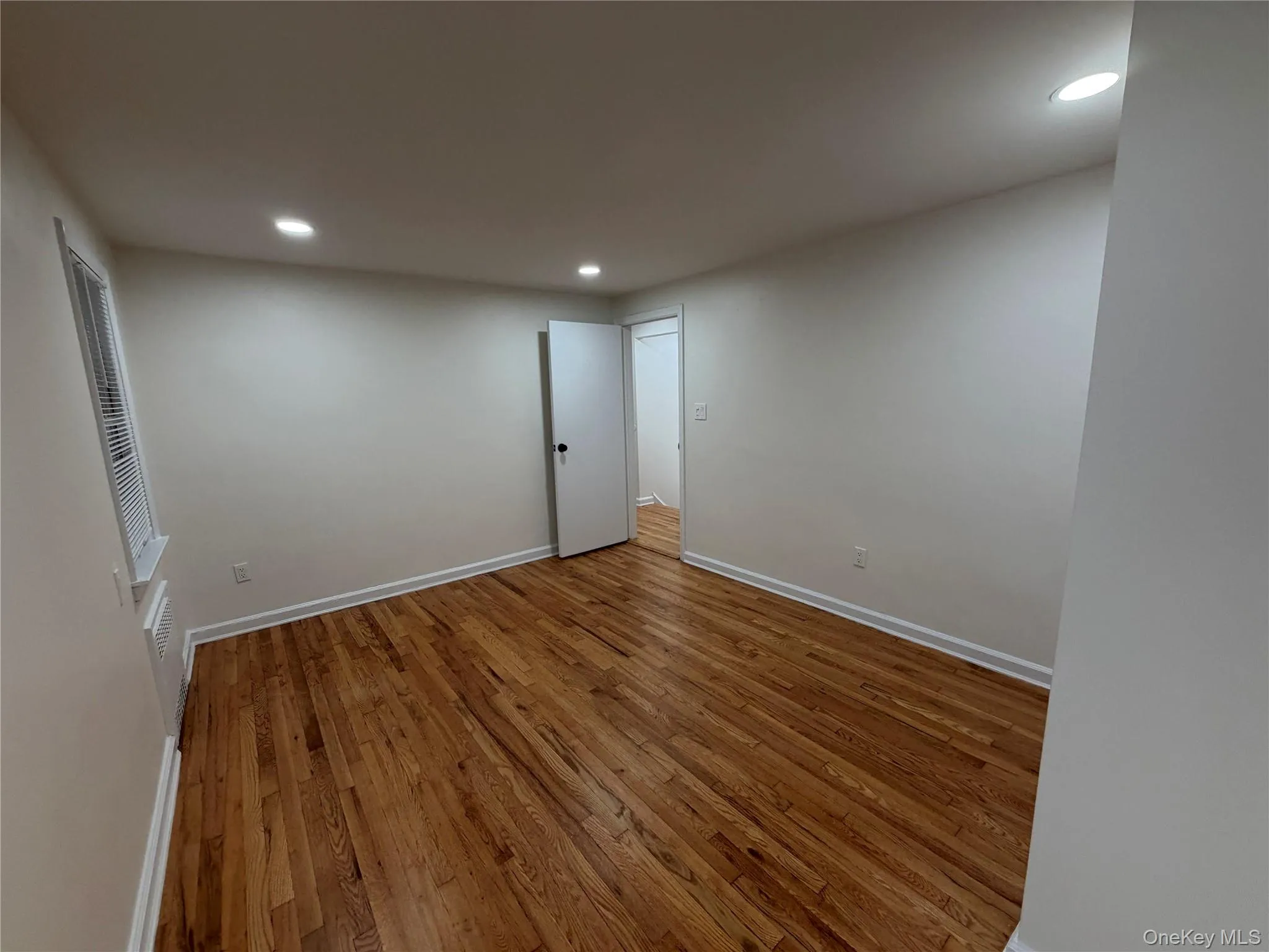 Empty room featuring hardwood / wood-style floors and recessed lighting Empty room featuring hardwood / wood-style floors and recessed lighting