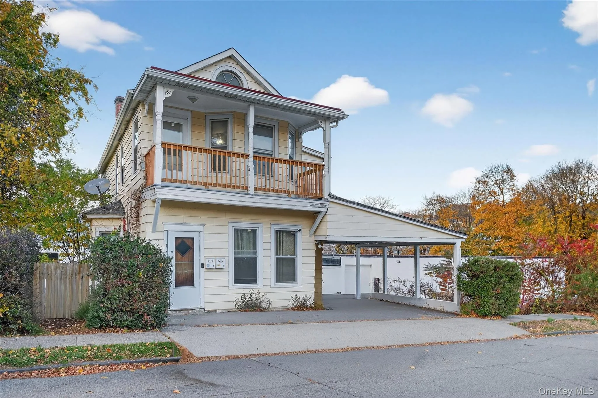 View of front of property with a carport, a porch, and driveway View of front of property with a carport, a porch, and driveway
