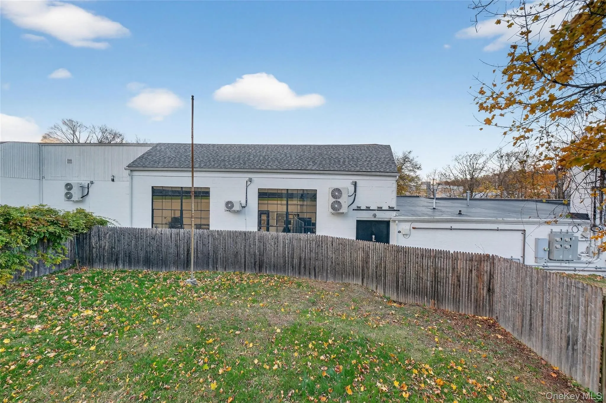 Rear view of property featuring a shingled roof Rear view of property featuring a shingled roof