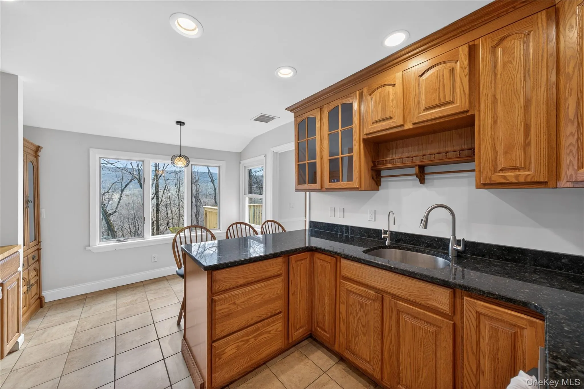 Black granite countertops and wood cabinets provide plenty of storage... Black granite countertops and wood cabinets provide plenty of storage...