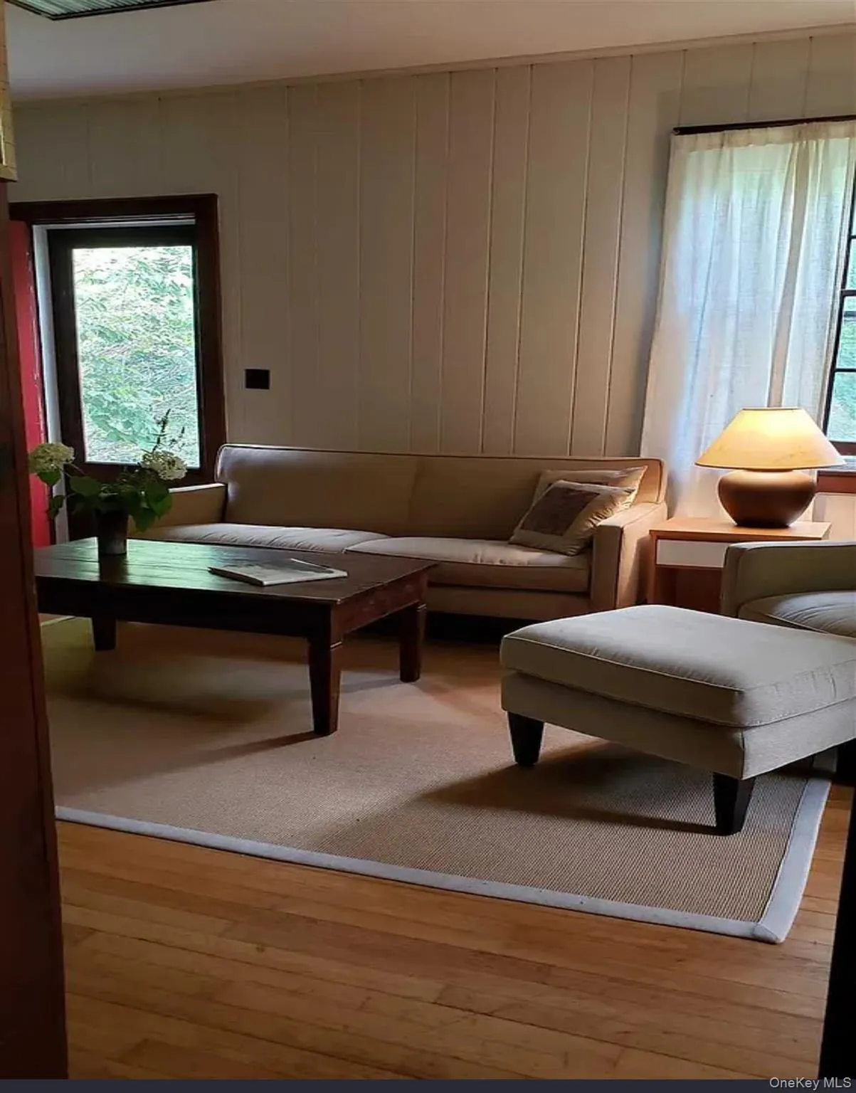 Wide windows frame the room with gentle daylight and views of the yard. Wide windows frame the room with gentle daylight and views of the yard.