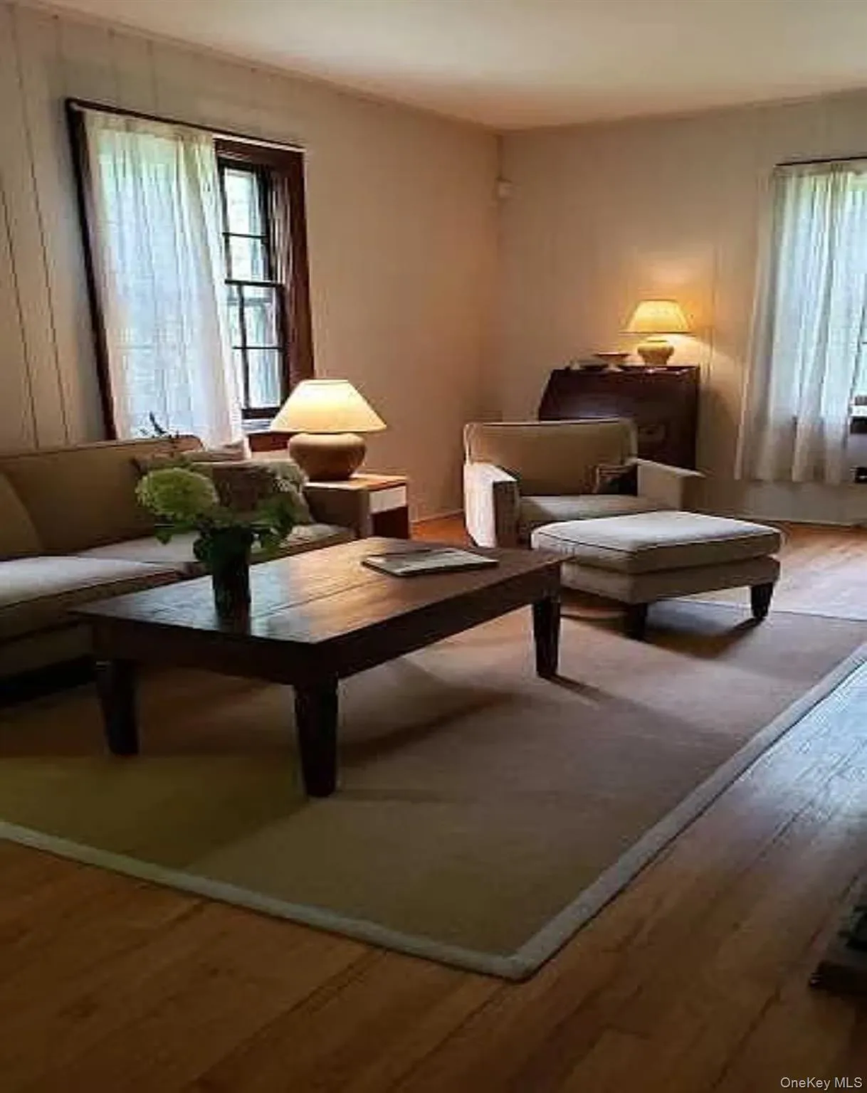 Sun-filled living room wrapped in warm pine accents and vintage charm Sun-filled living room wrapped in warm pine accents and vintage charm