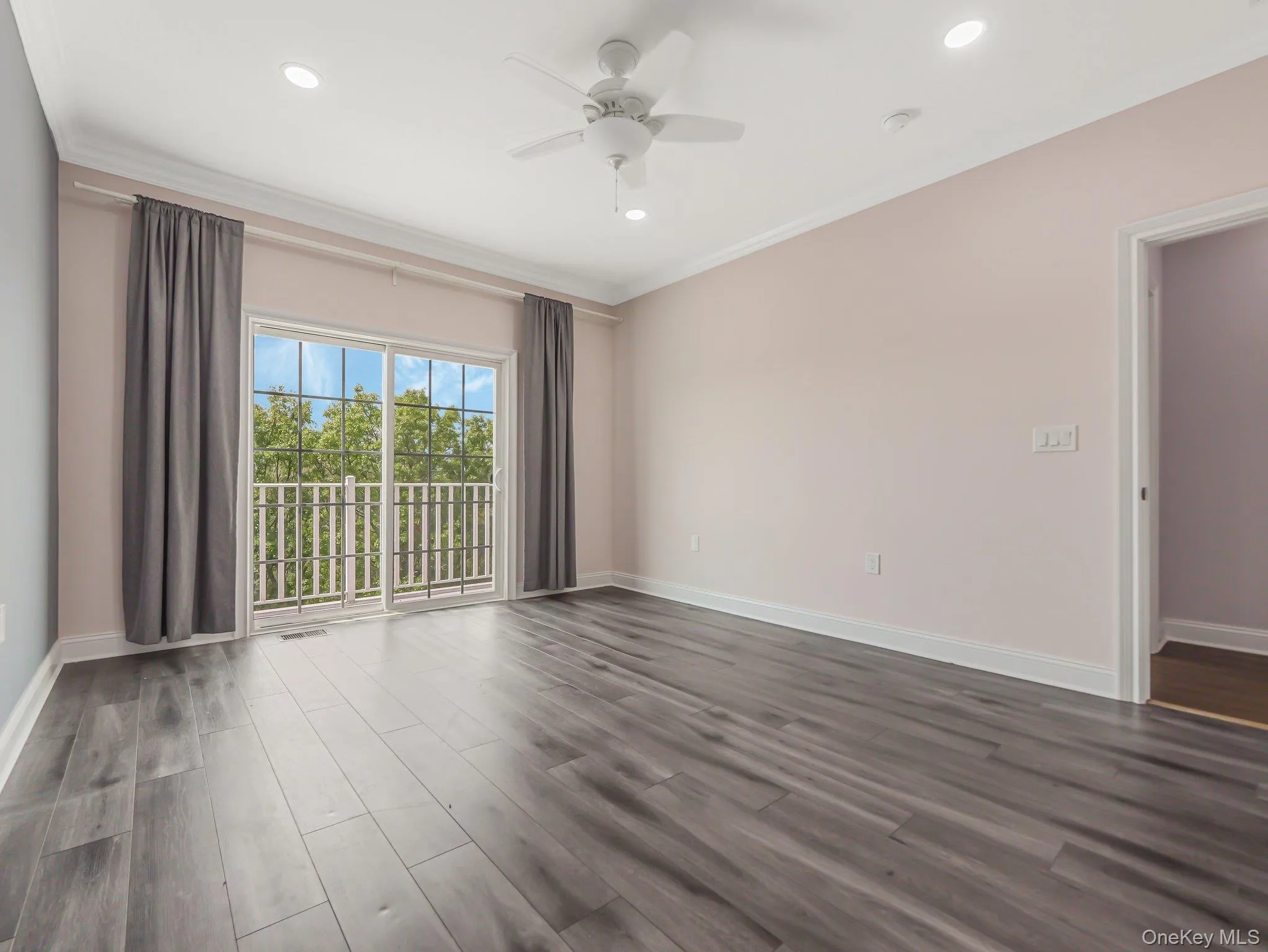 Empty room featuring dark wood-style flooring, ceiling fan, ornamental molding, and recessed lighting Empty room featuring dark wood-style flooring, ceiling fan, ornamental molding, and recessed lighting