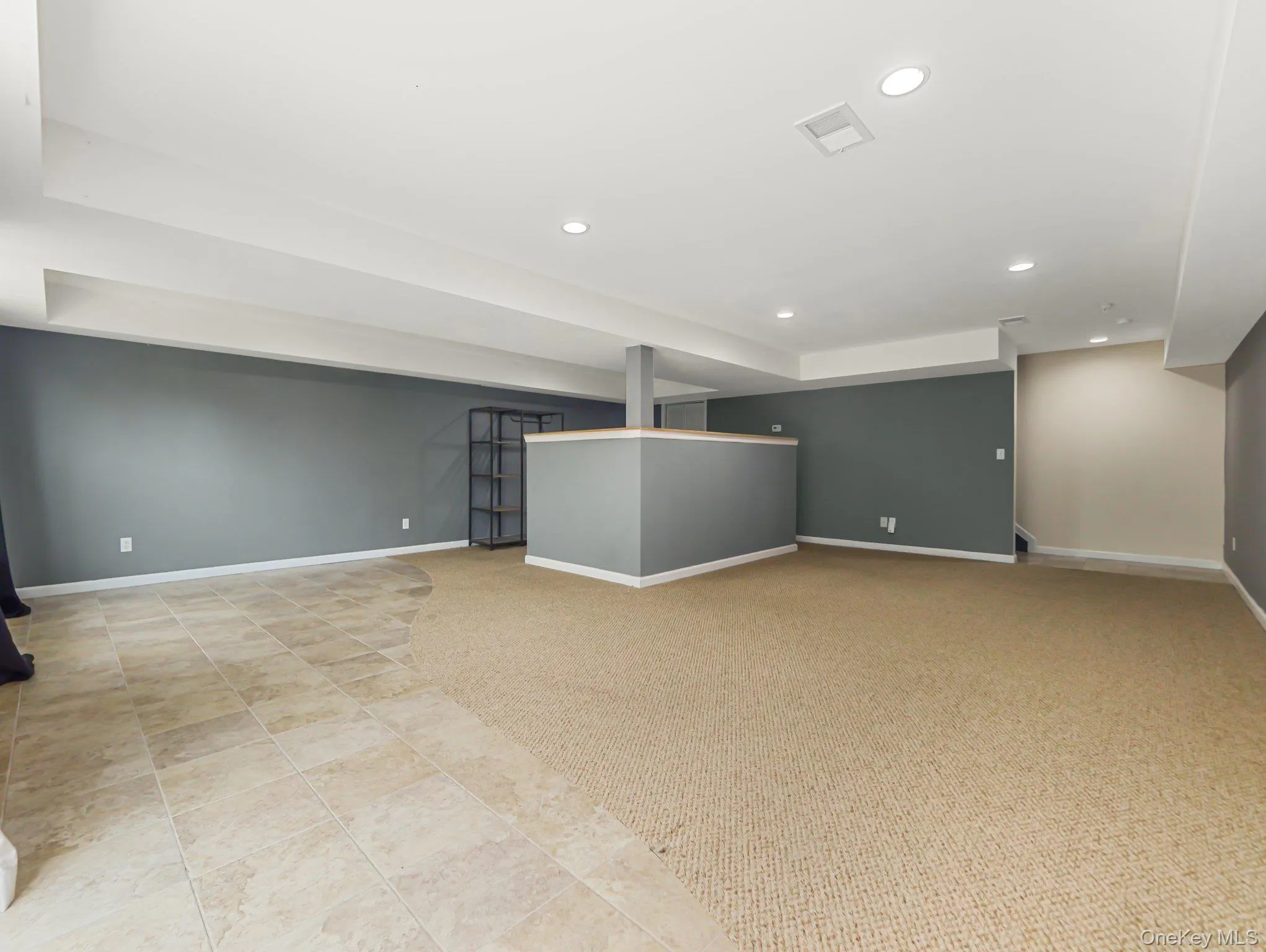 Finished below grade area featuring recessed lighting and light carpet Finished below grade area featuring recessed lighting and light carpet