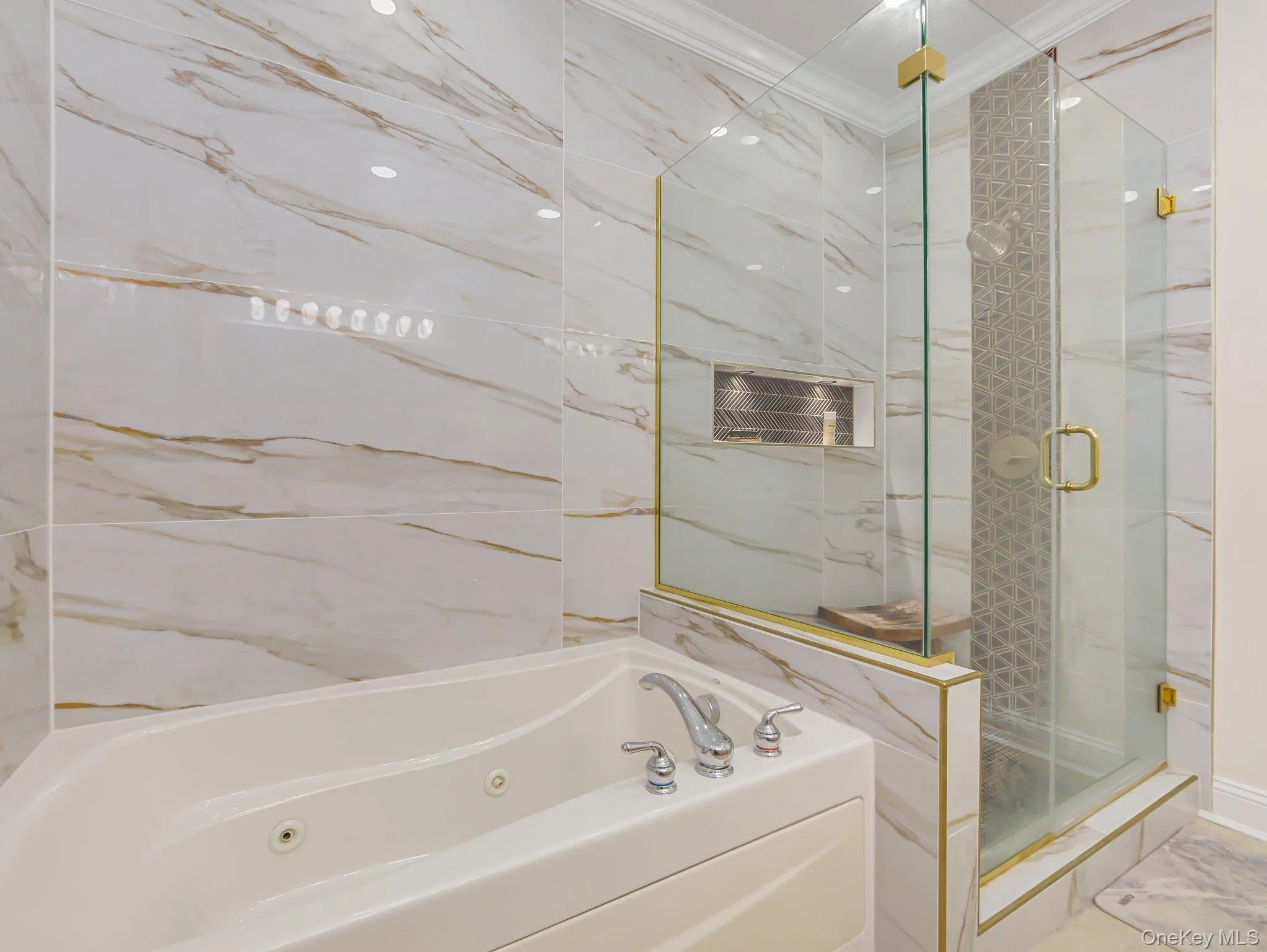 Bathroom with a tub with jets, a marble finish shower, and crown molding Bathroom with a tub with jets, a marble finish shower, and crown molding