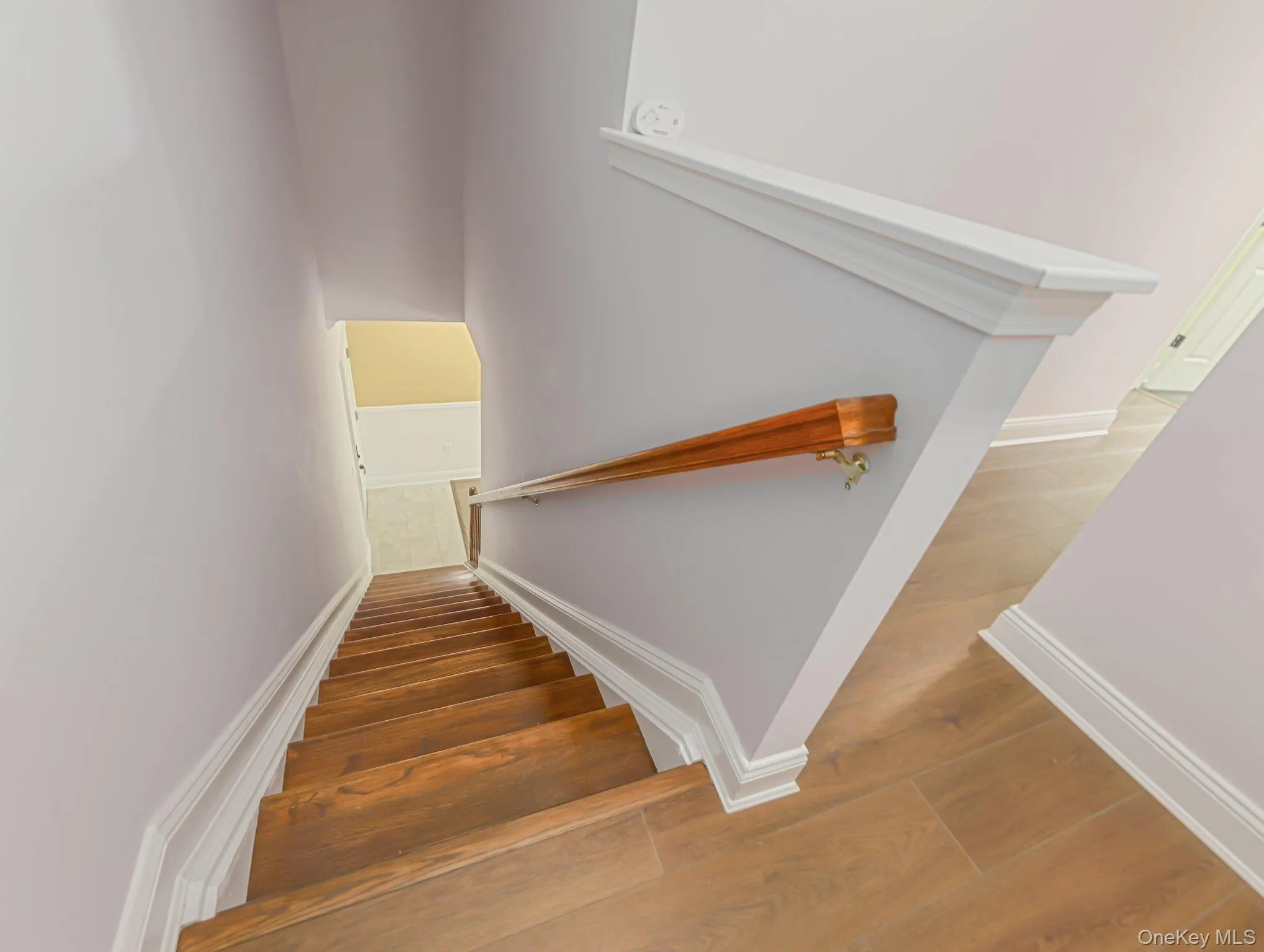 Stairway featuring wood finished floors and baseboards Stairway featuring wood finished floors and baseboards