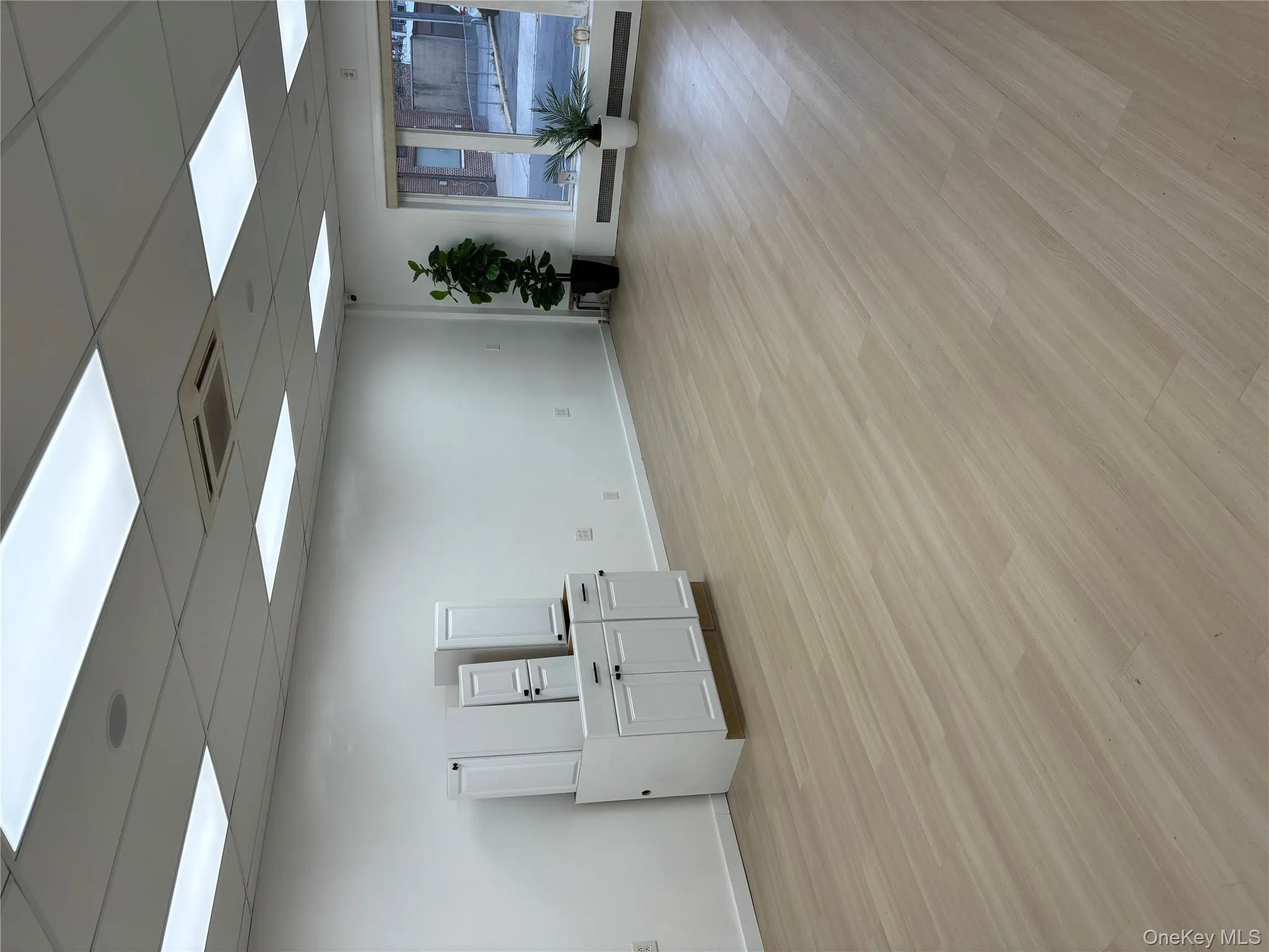 Unfurnished room with light wood-style flooring and a drop ceiling Unfurnished room with light wood-style flooring and a drop ceiling