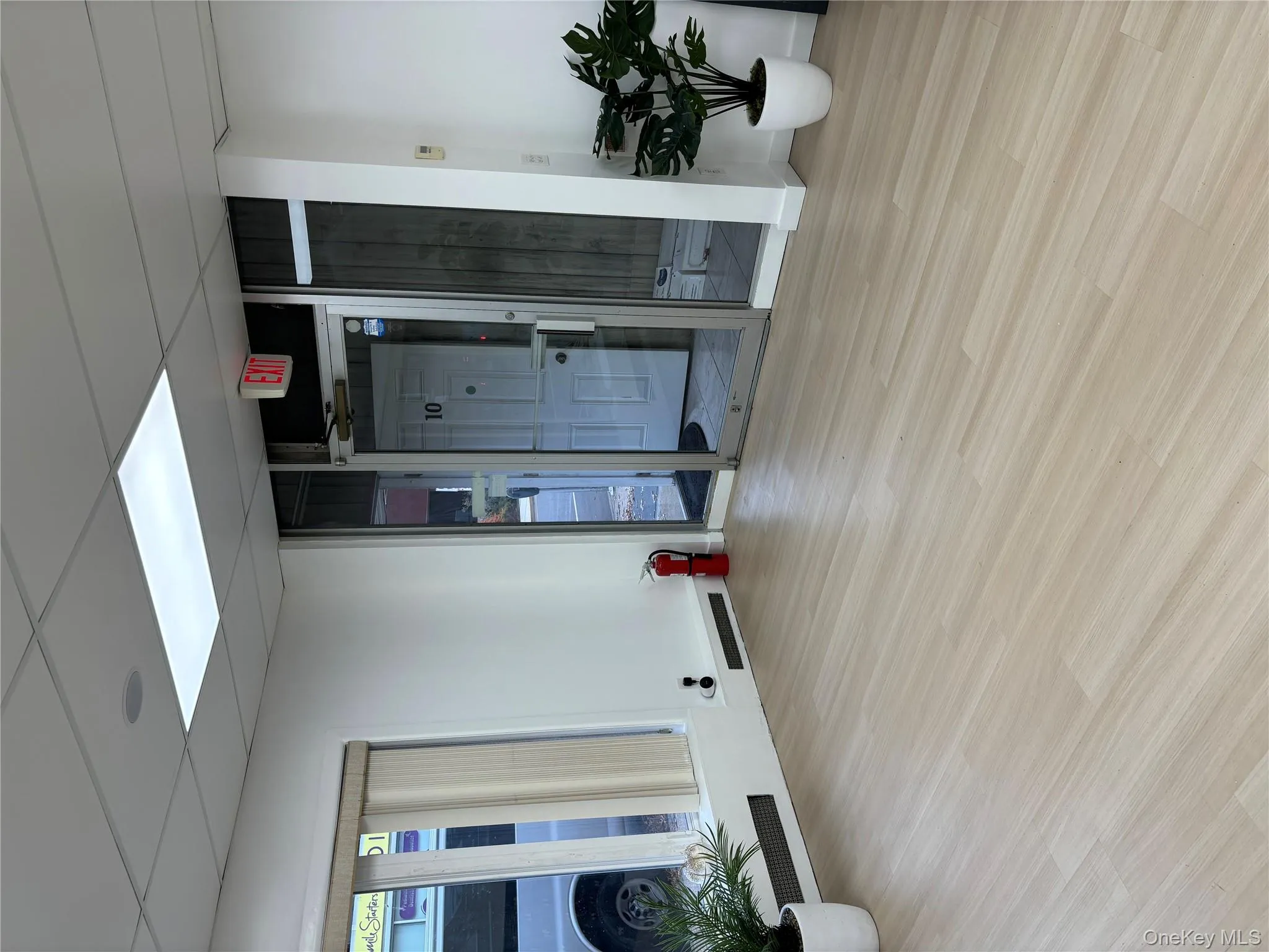 Empty room with light wood-style floors and a drop ceiling Empty room with light wood-style floors and a drop ceiling