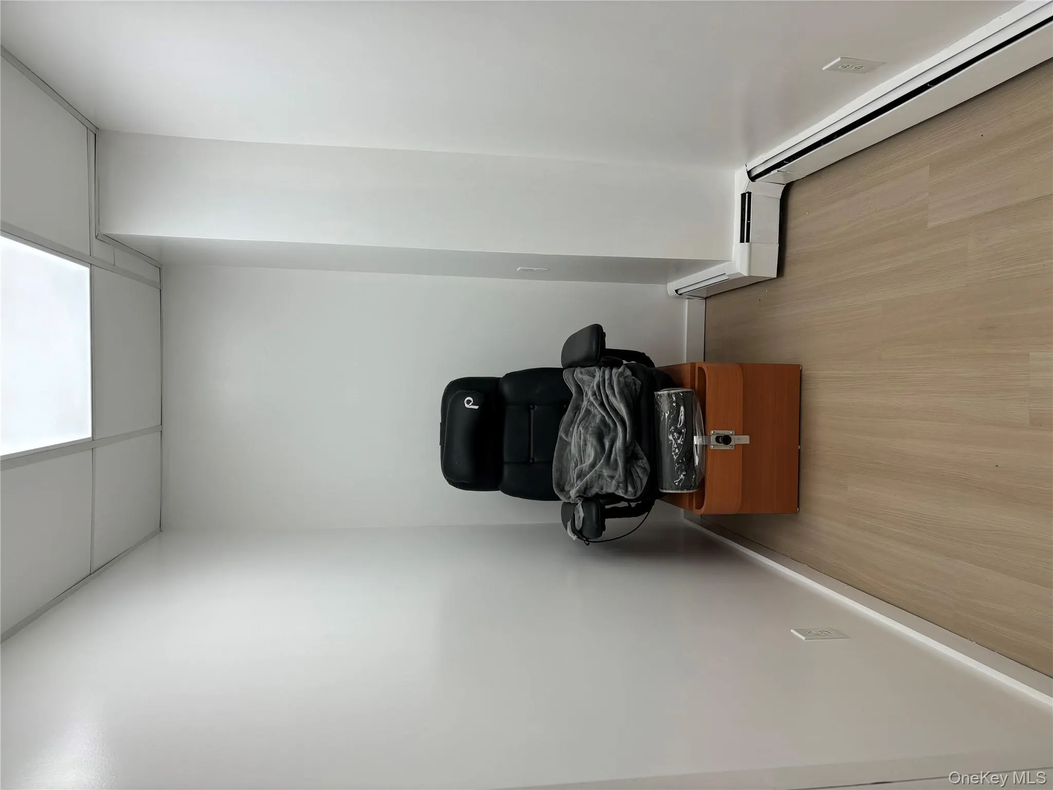 Miscellaneous room featuring a baseboard heating unit, a drop ceiling, and light wood-type flooring Miscellaneous room featuring a baseboard heating unit, a drop ceiling, and light wood-type flooring