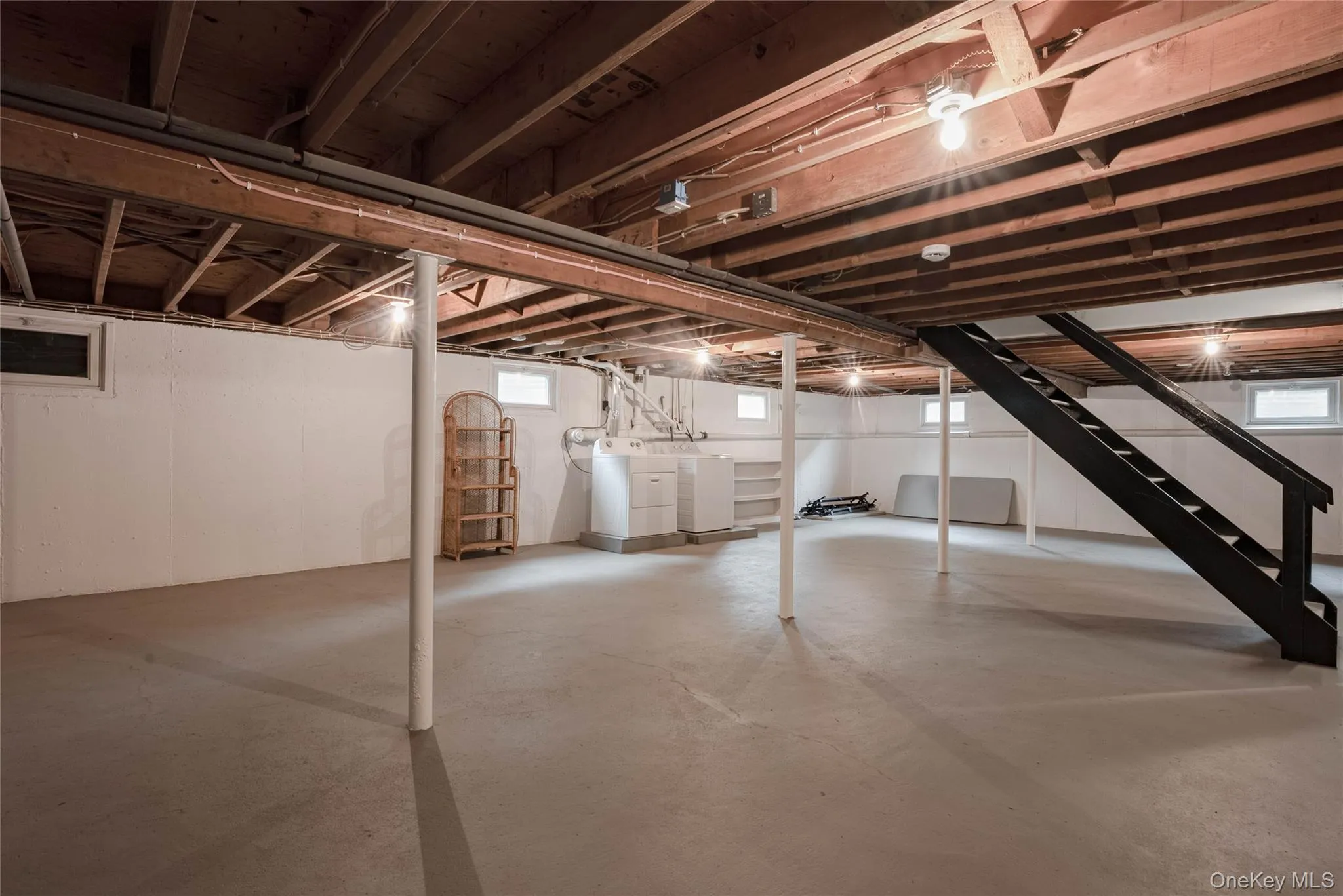 Basement with stairs and separate washer and dryer Basement with stairs and separate washer and dryer