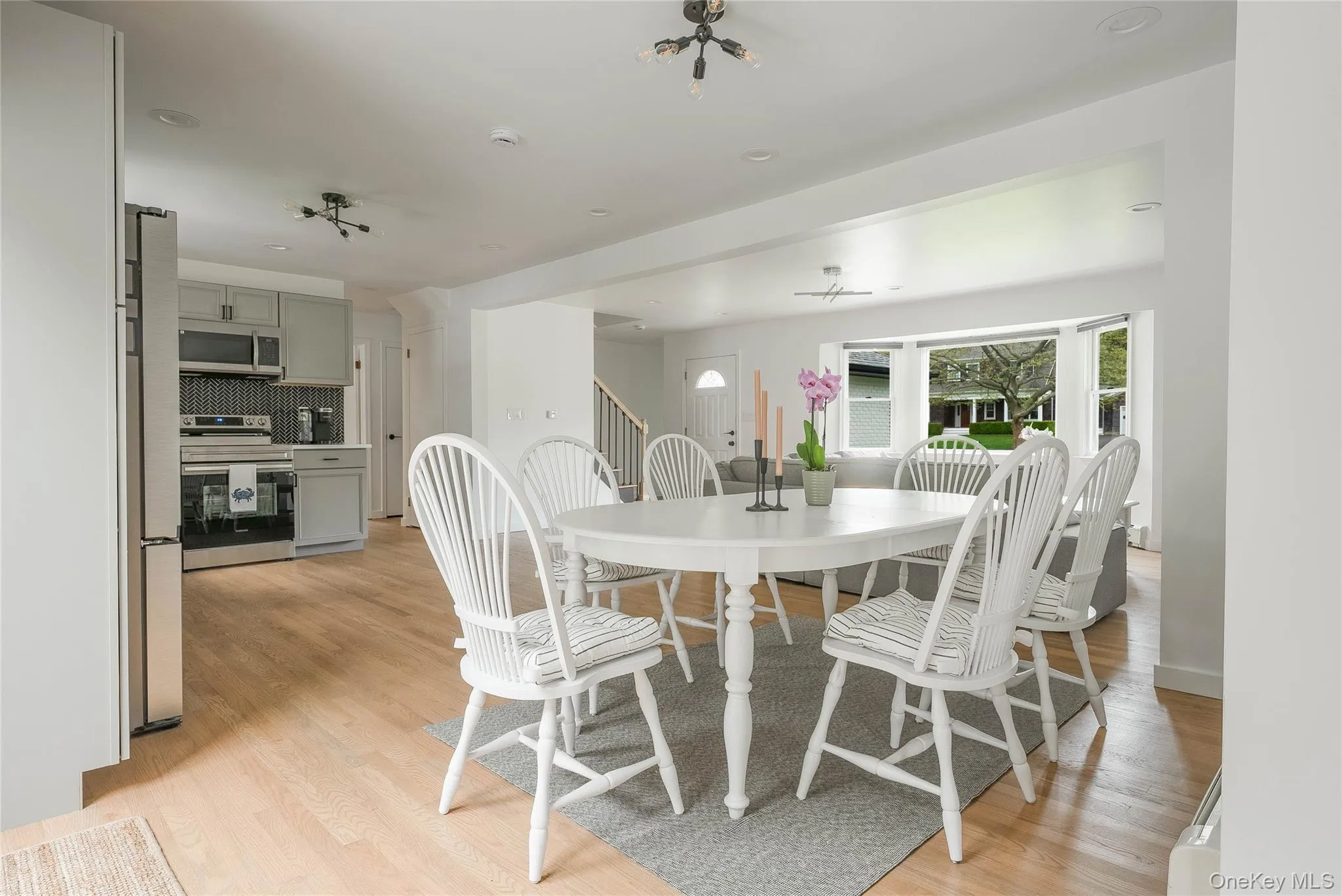 Dining space featuring light wood-style floors and stairway Dining space featuring light wood-style floors and stairway