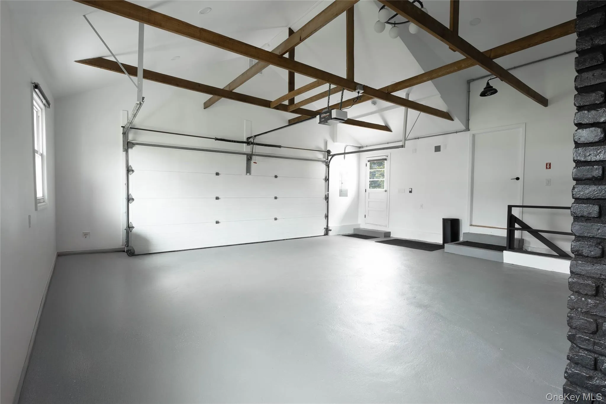 Garage featuring a garage door opener and baseboards Garage featuring a garage door opener and baseboards