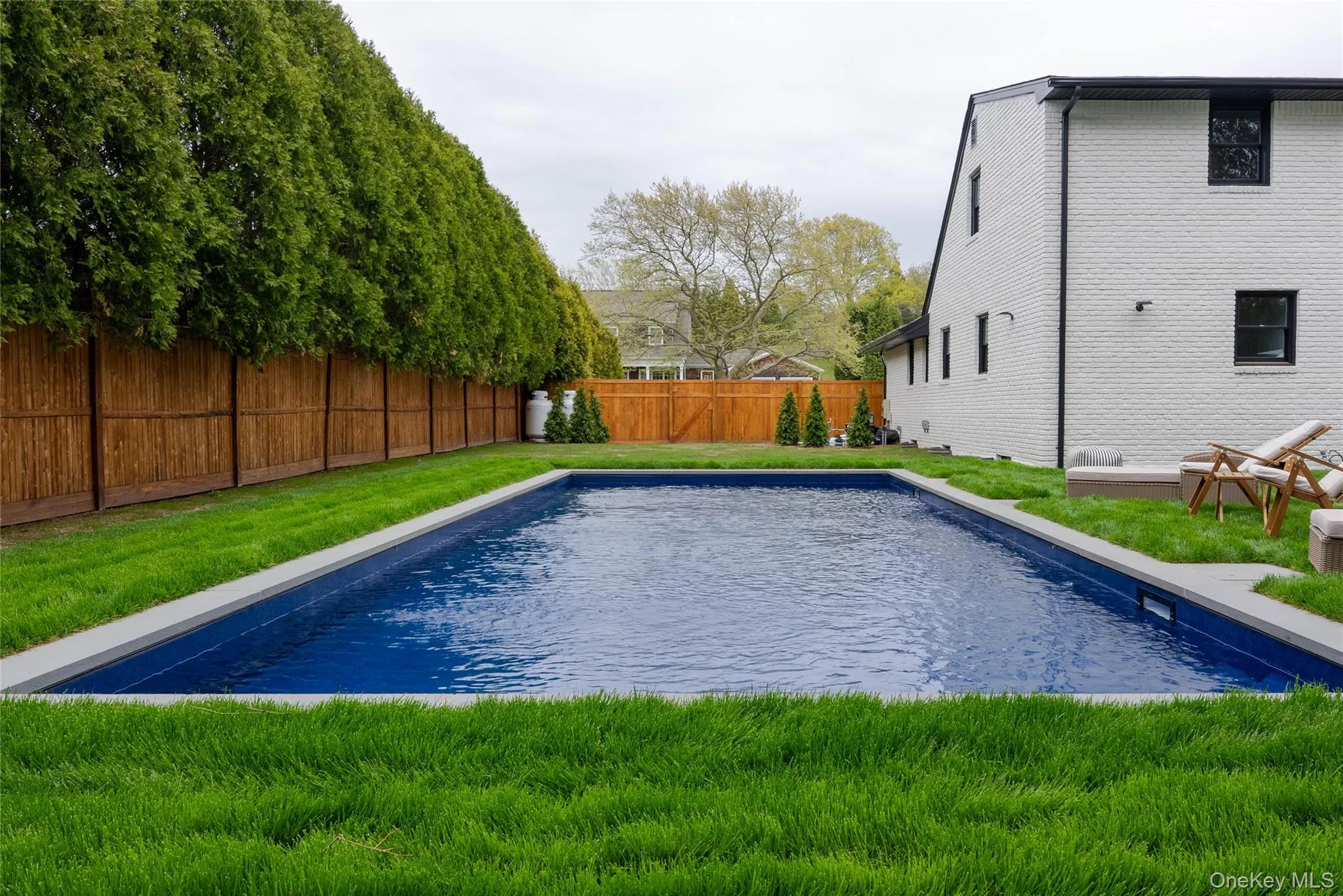 View of pool featuring a fenced backyard and a patio area View of pool featuring a fenced backyard and a patio area