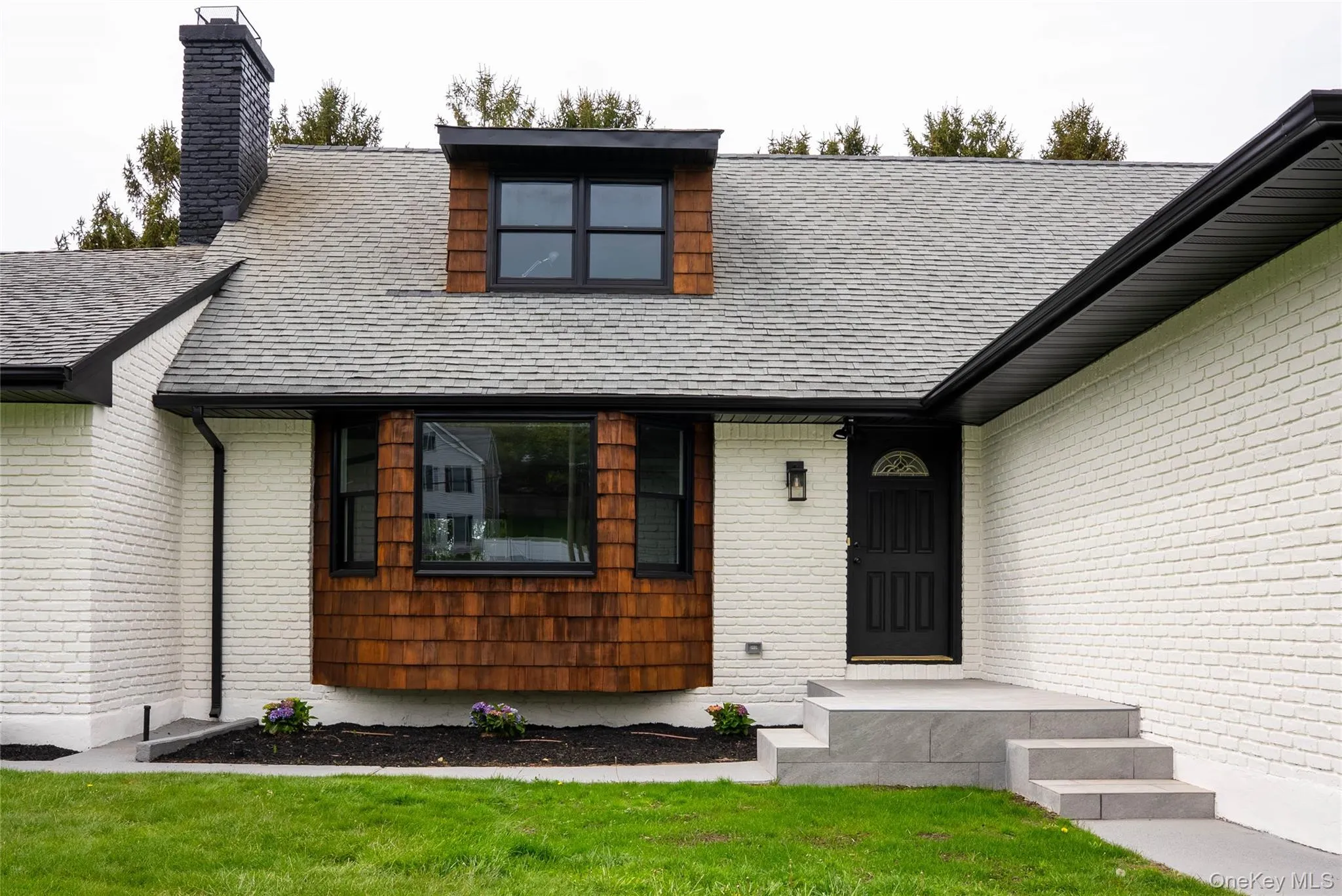 View of front of property featuring a chimney, a shingled roof, and a front lawn View of front of property featuring a chimney, a shingled roof, and a front lawn