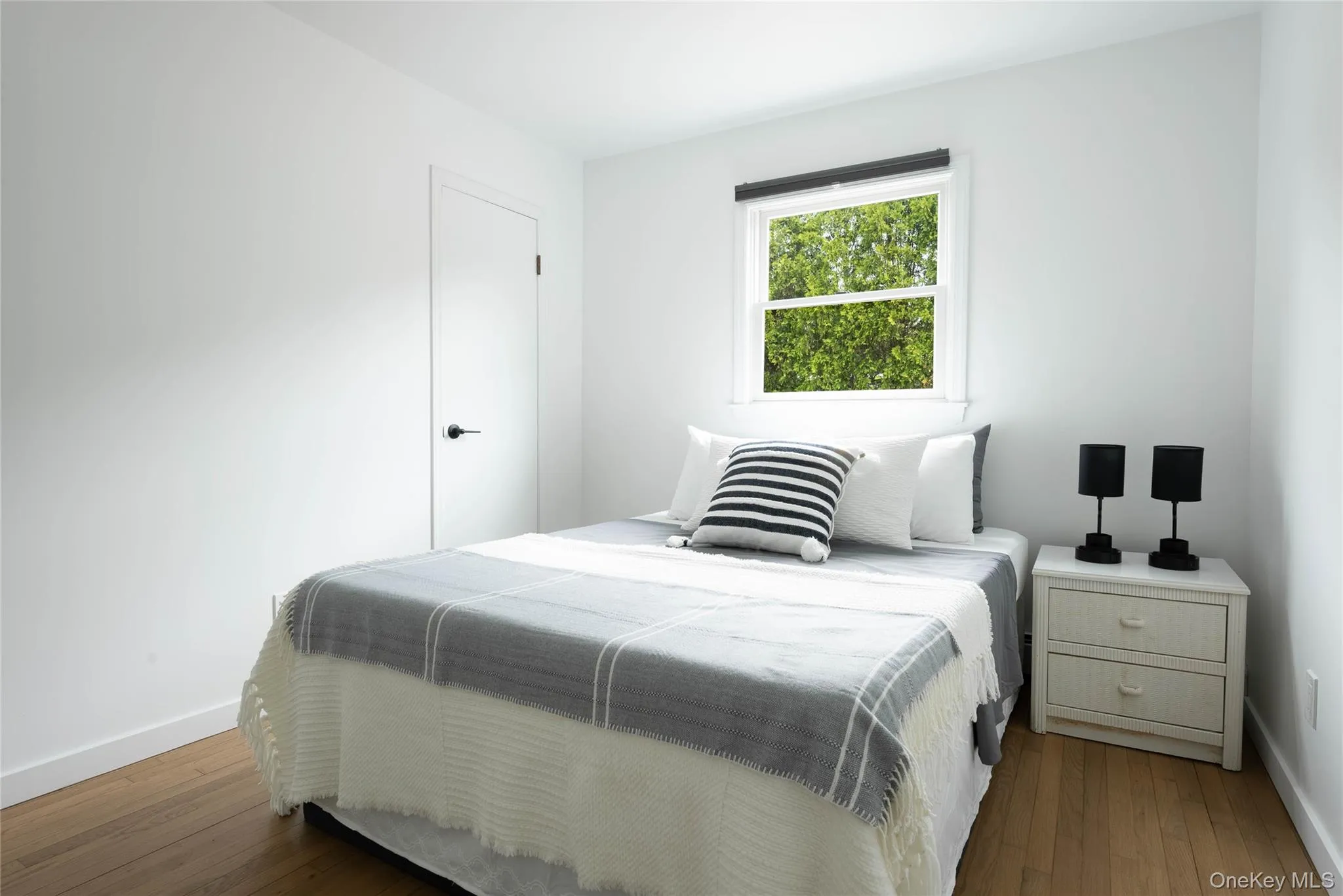 Bedroom with baseboards and wood-type flooring Bedroom with baseboards and wood-type flooring