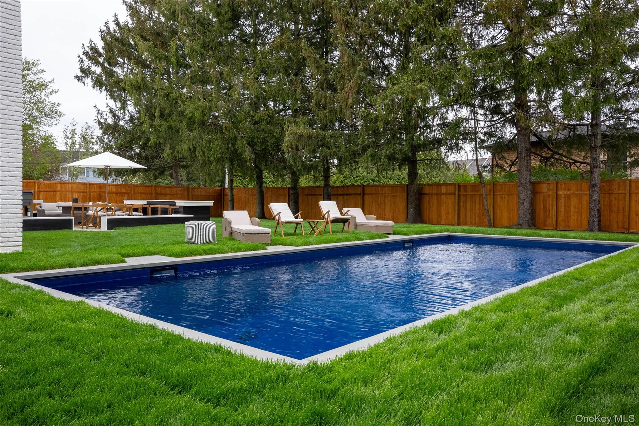 View of pool featuring a fenced backyard, a patio, and an outdoor hangout area View of pool featuring a fenced backyard, a patio, and an outdoor hangout area