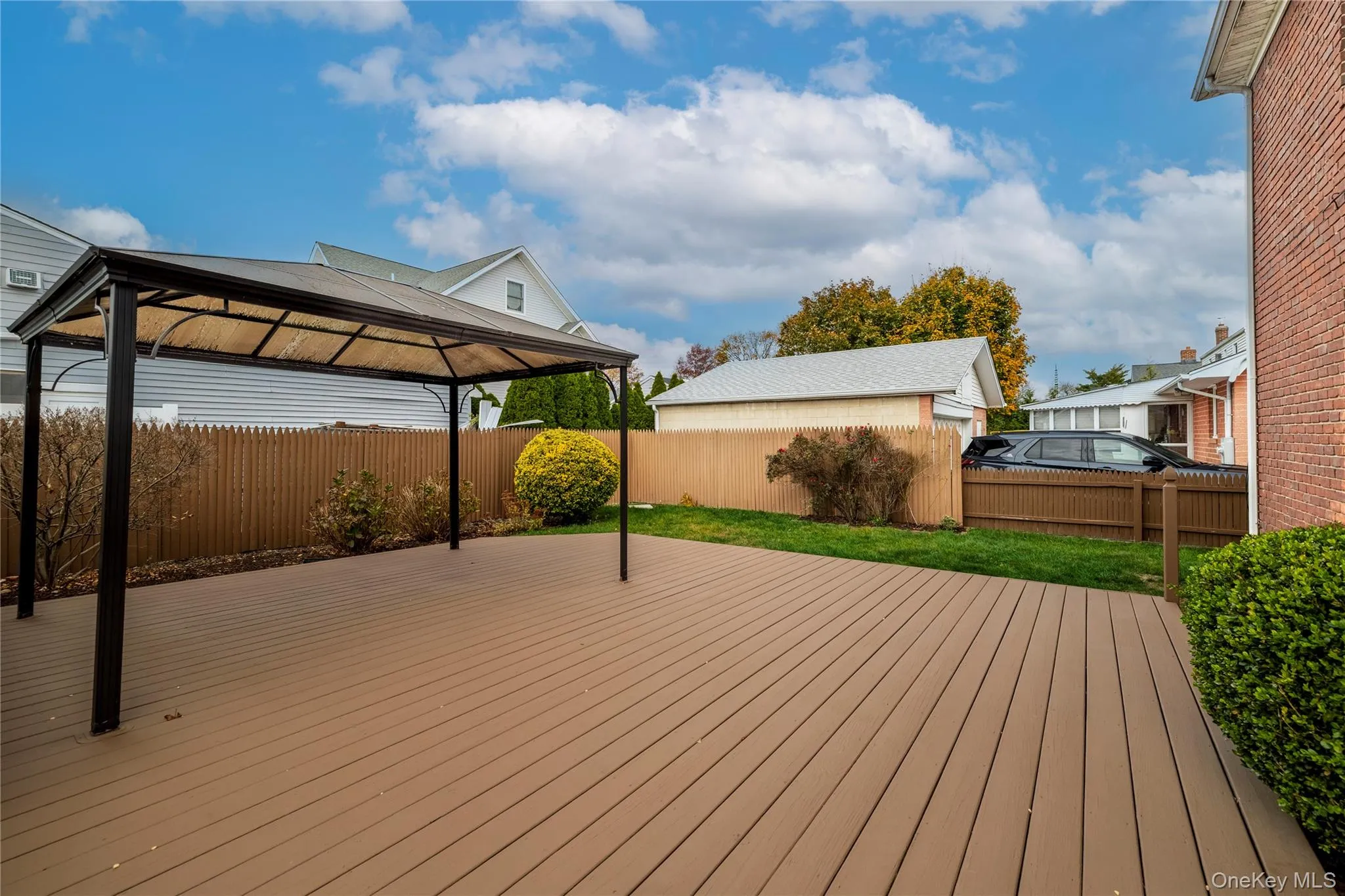 Wooden deck with a fenced backyard and a gazebo Wooden deck with a fenced backyard and a gazebo