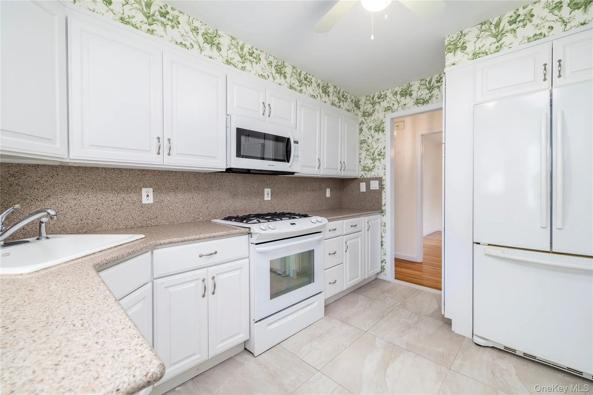 1st Floor Kitchen with white appliances and white cabinetry 1st Floor Kitchen with white appliances and white cabinetry