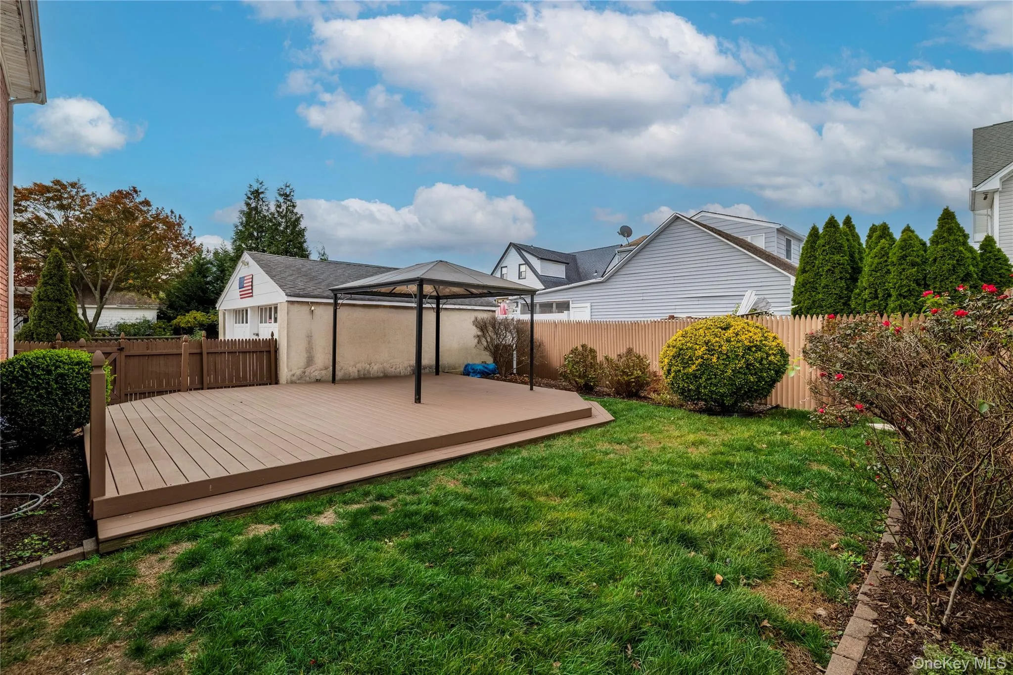 Fenced backyard featuring a deck Fenced backyard featuring a deck