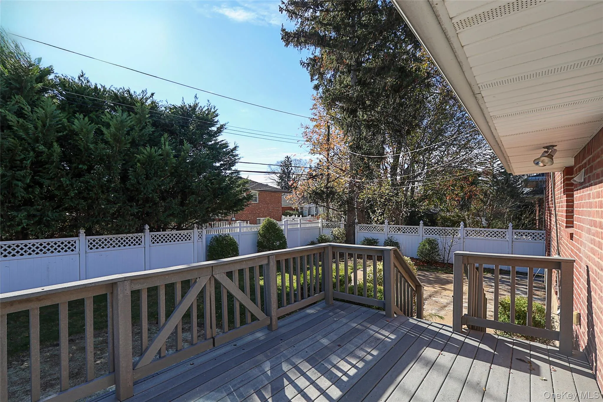 Wooden terrace featuring a fenced backyard Wooden terrace featuring a fenced backyard