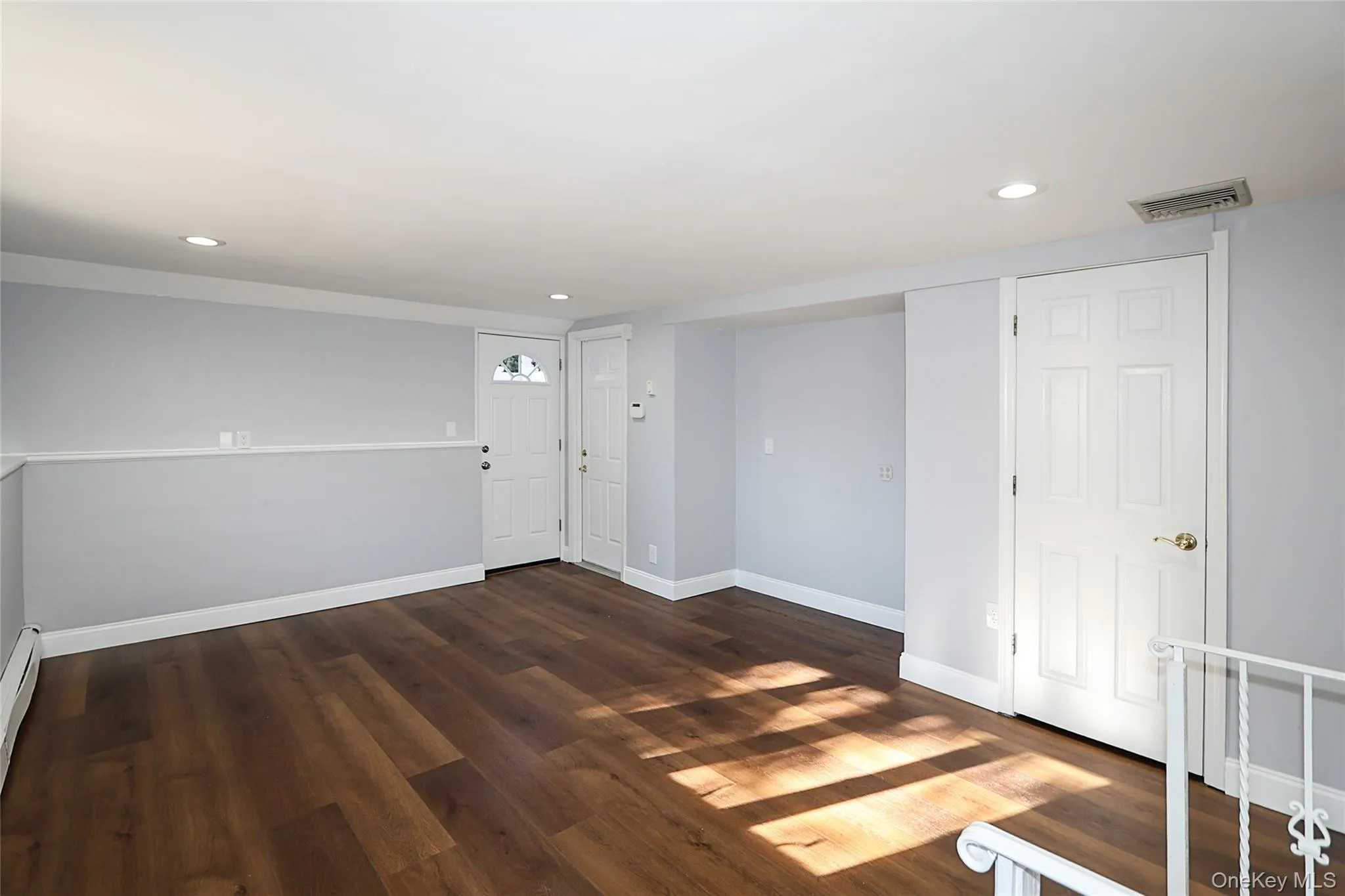Spare room featuring dark wood finished floors and recessed lighting Spare room featuring dark wood finished floors and recessed lighting