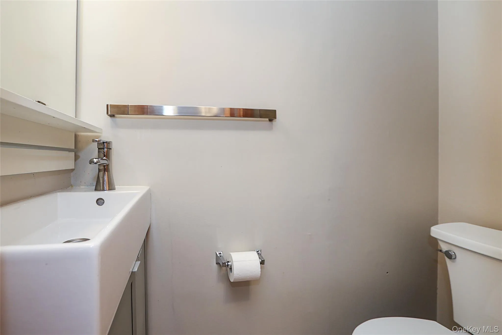 Half bathroom with toilet and vanity Half bathroom with toilet and vanity