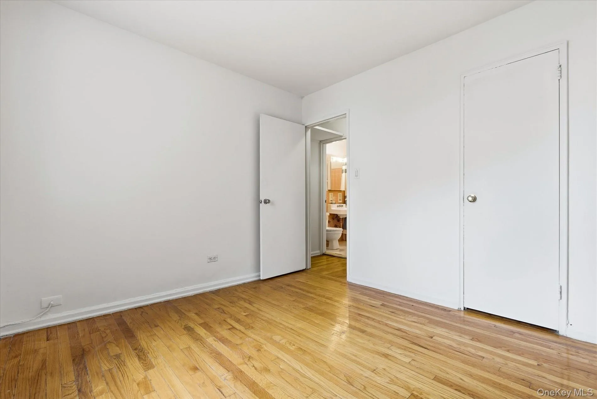 Unfurnished bedroom featuring light wood finished floors and baseboards Unfurnished bedroom featuring light wood finished floors and baseboards