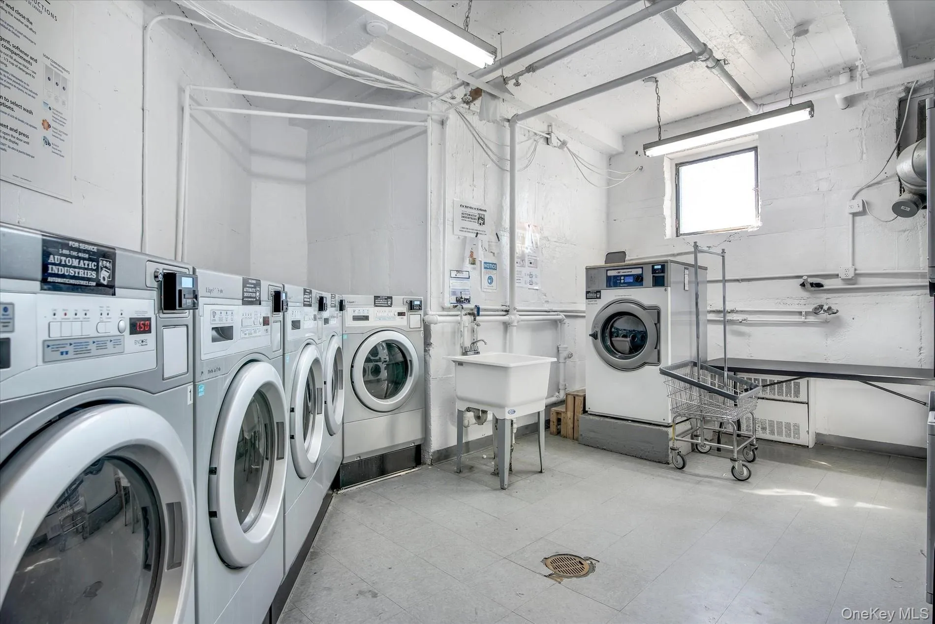 Communal laundry room with separate washer and dryer Communal laundry room with separate washer and dryer