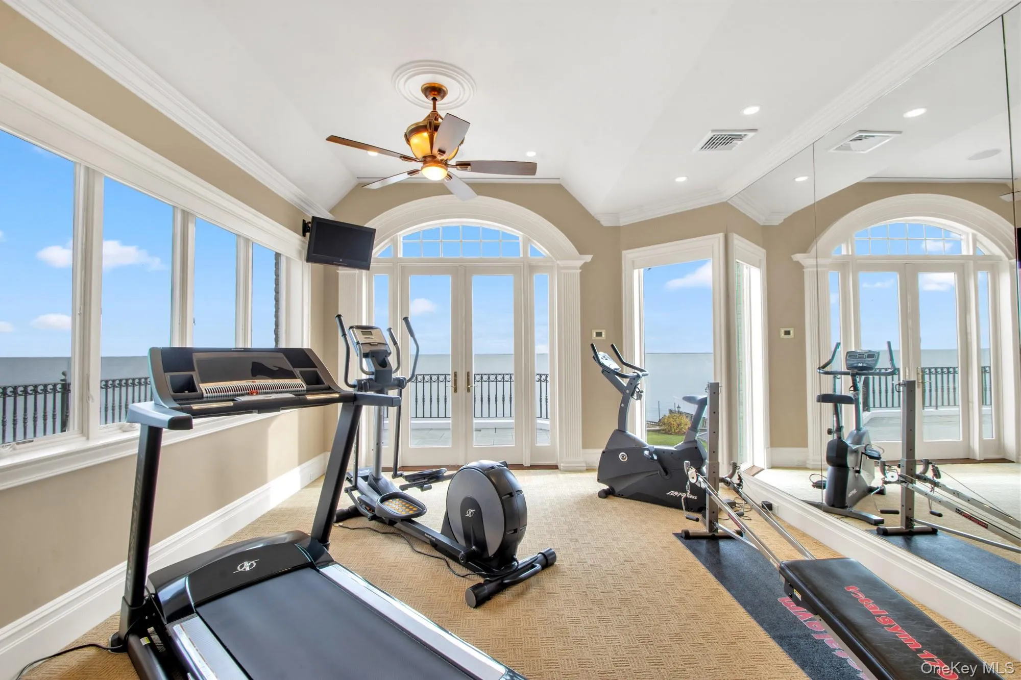 Exercise area featuring french doors, ornamental molding, carpet flooring, a ceiling fan, and recessed lighting Exercise area featuring french doors, ornamental molding, carpet flooring, a ceiling fan, and recessed lighting