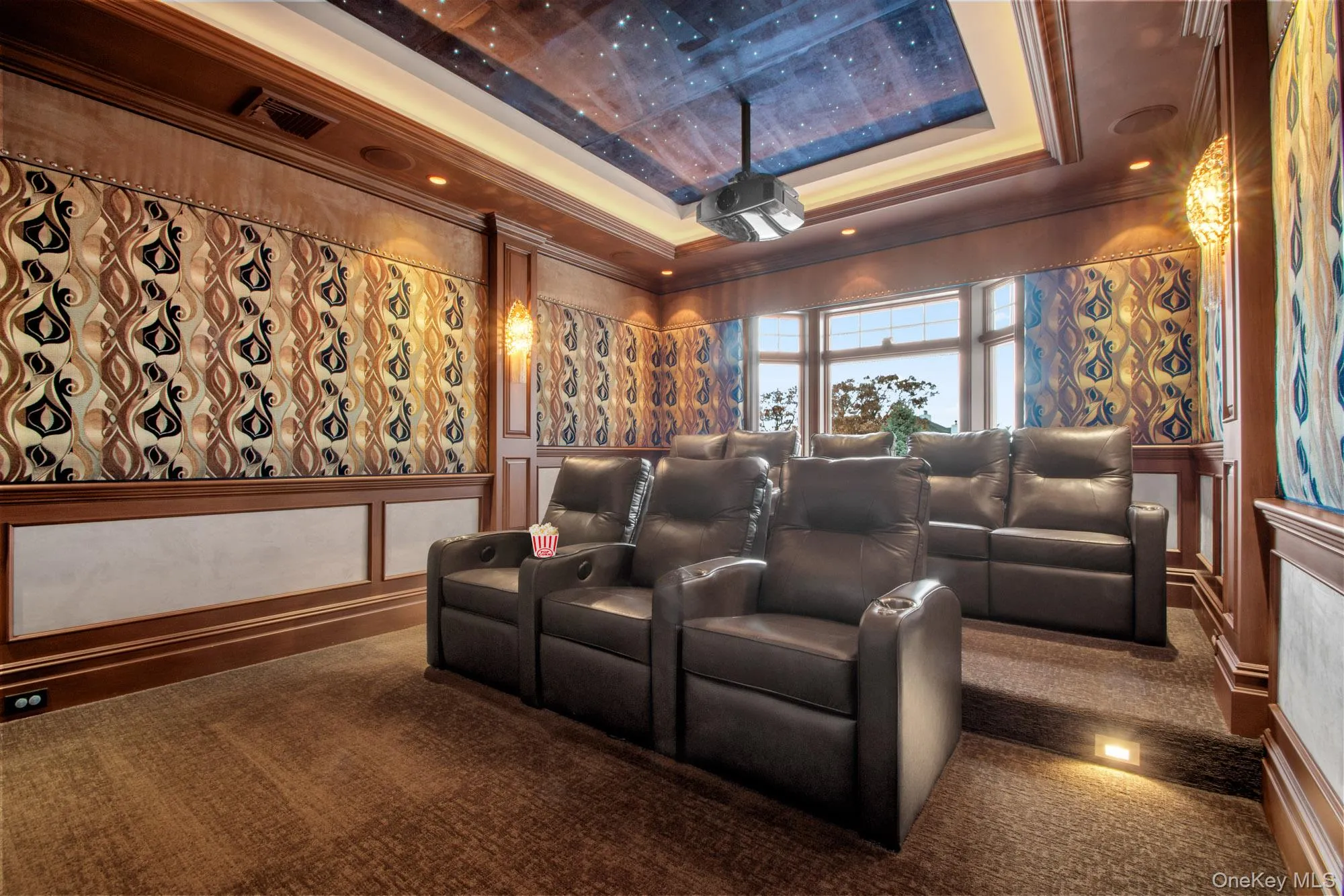 Home theater featuring crown molding, a decorative wall, a raised ceiling, carpet flooring, and recessed lighting Home theater featuring crown molding, a decorative wall, a raised ceiling, carpet flooring, and recessed lighting